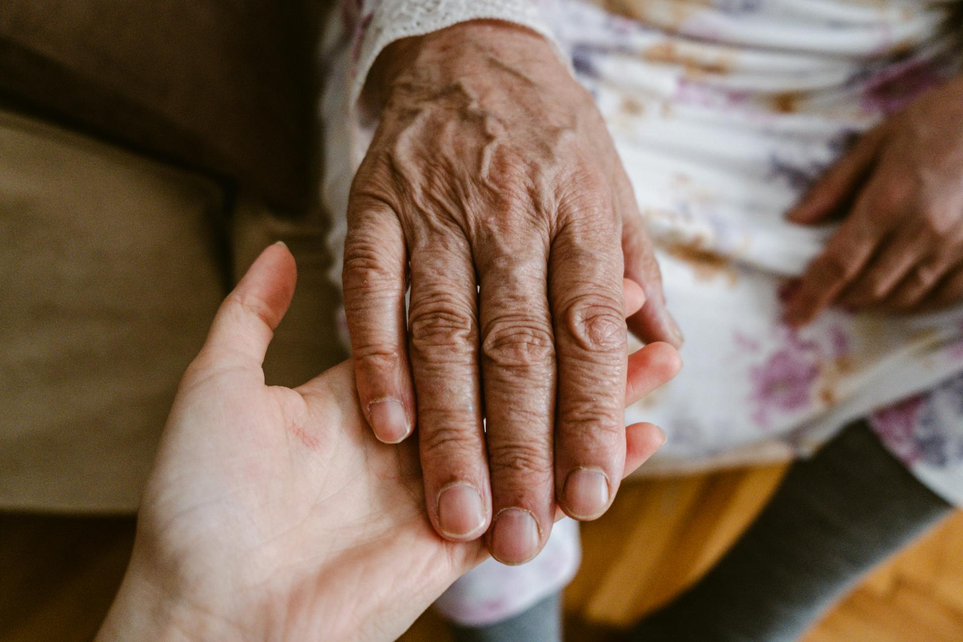 A woman holding an older woman's hand | Source: Pexels