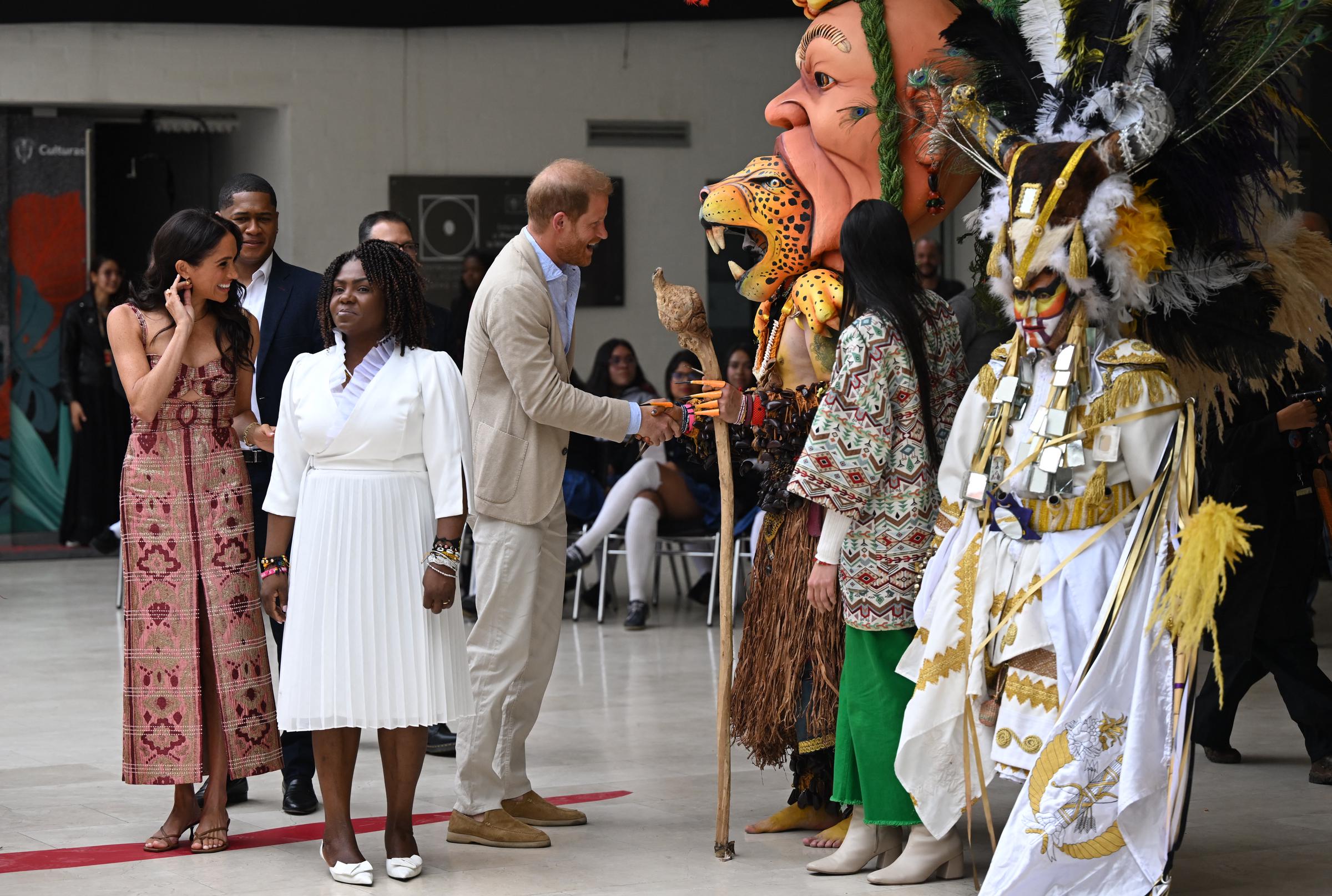 Meghan Markle talks with Colombia's Vice President, Francia Márquez, while Prince Harry shakes hands with a man wearing a traditional outfit at the Centro Nacional de las Artes Delia Zapata in Bogotá on August 15, 2024 | Source: Getty Images