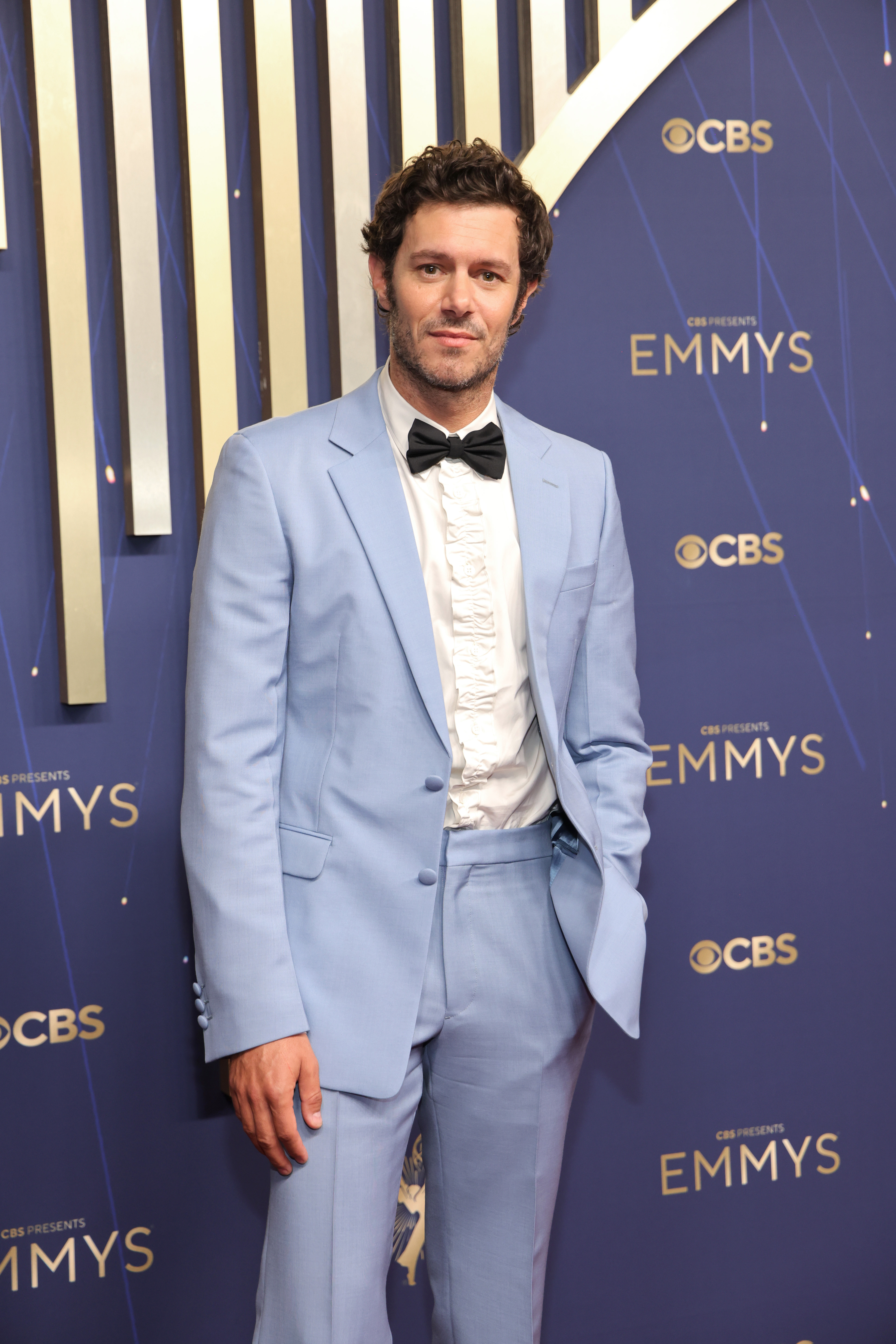 By 2025, Brody had traded his surfer-kid aesthetic for red carpet sophistication, appearing at the Emmys in a powder blue tuxedo with a ruffled shirt and bow tie. With a touch of scruff and salt-and-pepper curls, he exuded grown-up charm while continuing to earn praise for roles in projects like "Fleishman Is in Trouble" and the "Shazam!" films.