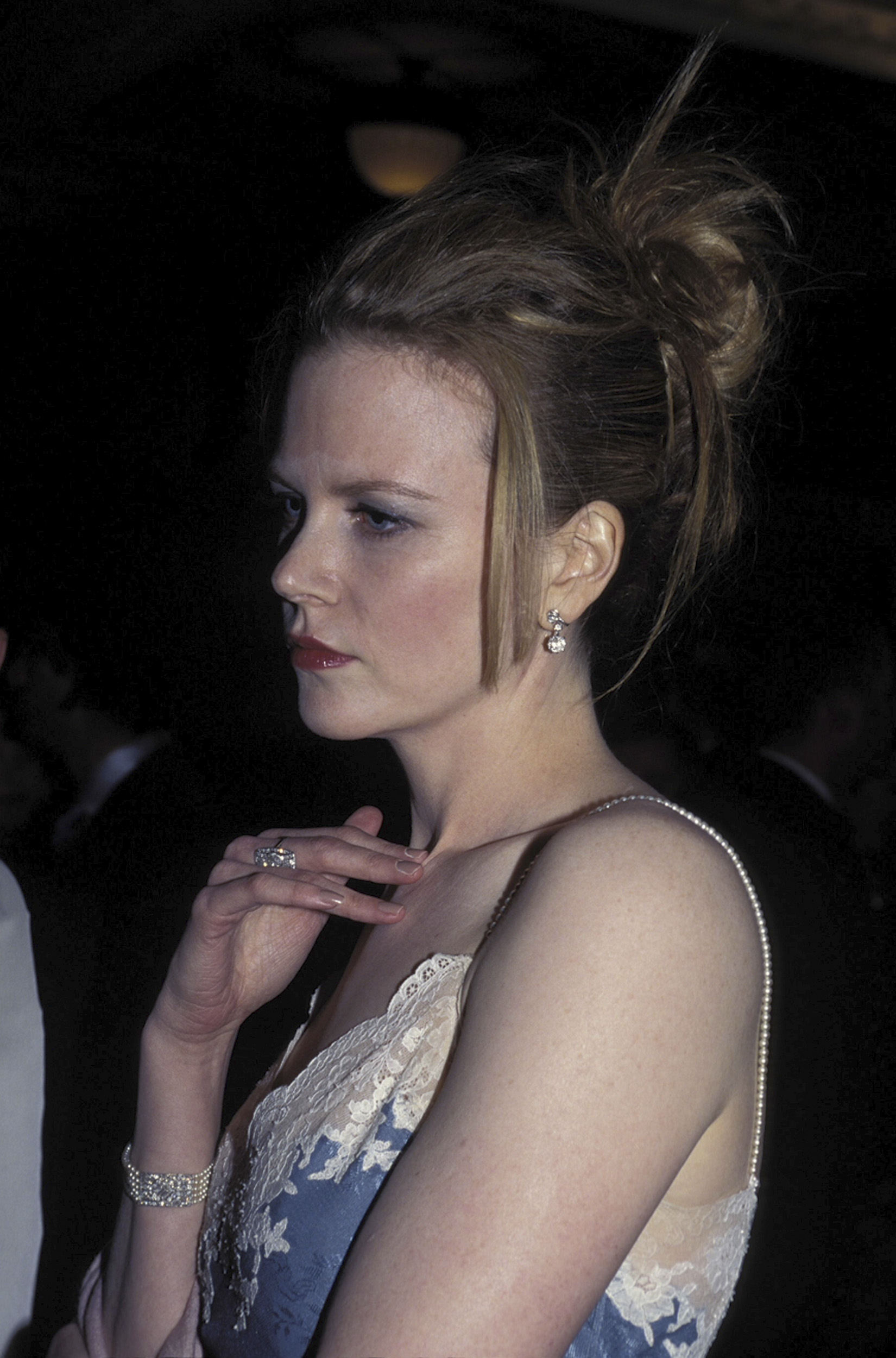 Nicole Kidman at the AFI Awards in Sydney with her hair styled in a sleek updo. The natural curls are completely smoothed out, with a few straightened strands left loose at the front, signaling a clear move away from her natural texture.