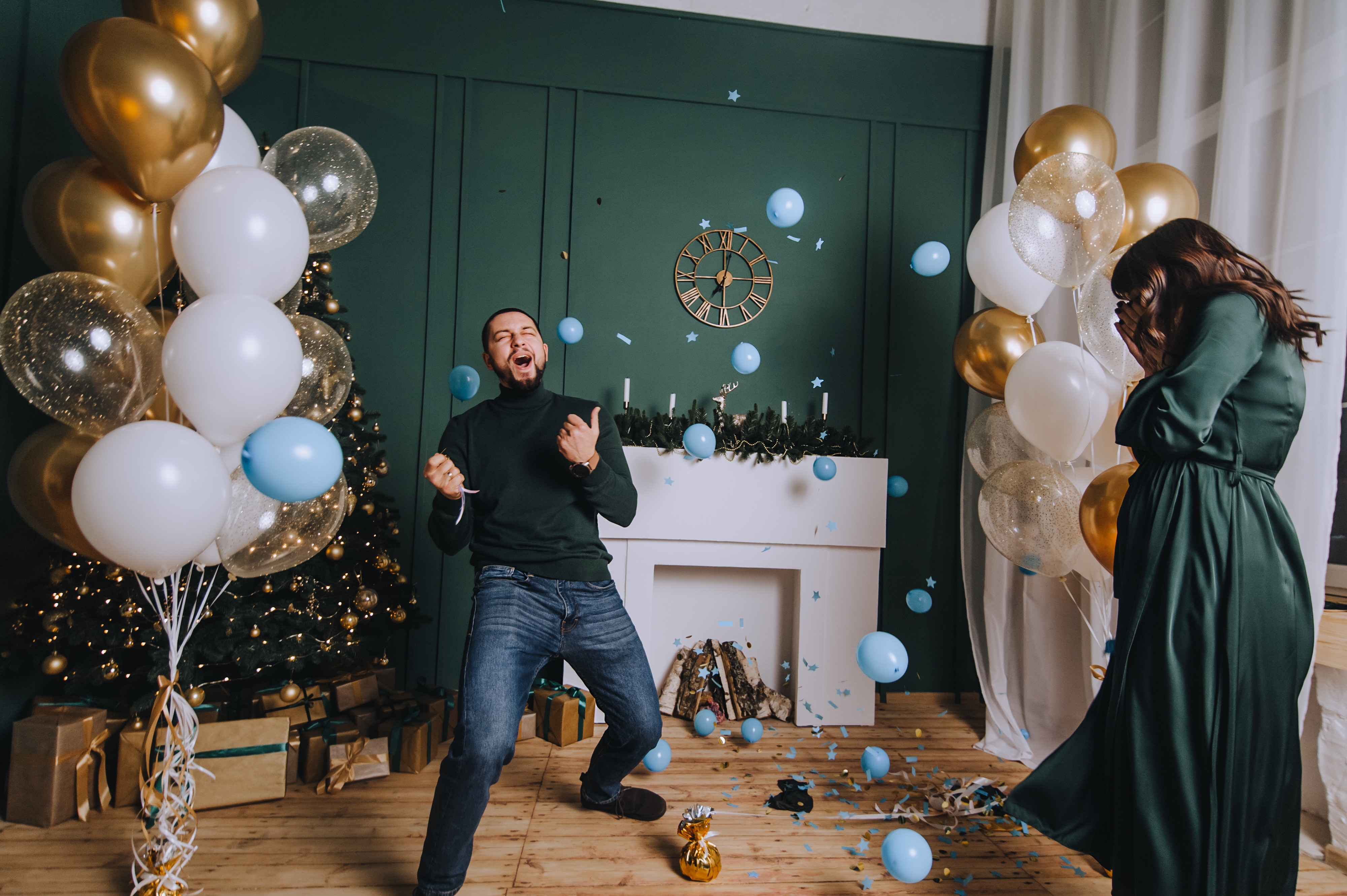 A man surrounded by blue balloons excitedly celebrating | Source: Shutterstock