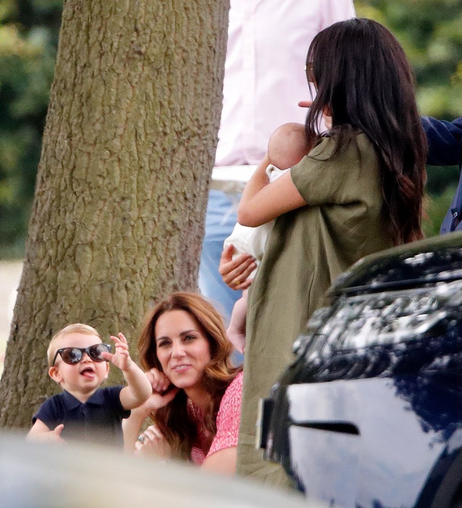 Prince Louis and Kate Middleton greet Meghan Markle and Archie Harrison at a charity polo match in July 2019 | Photo: Getty Images