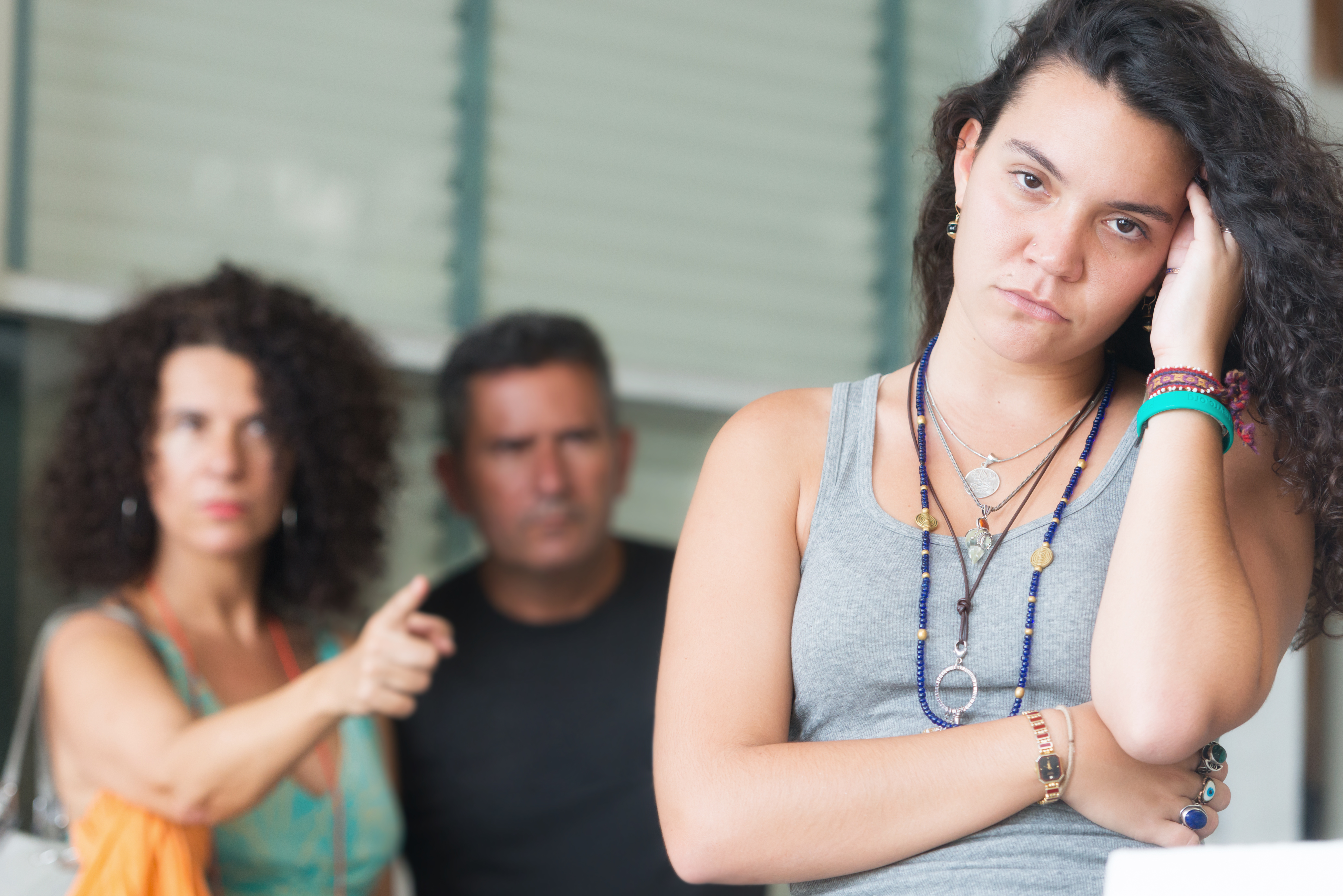 Parents scolding their adult daughter. | Source: Getty Images