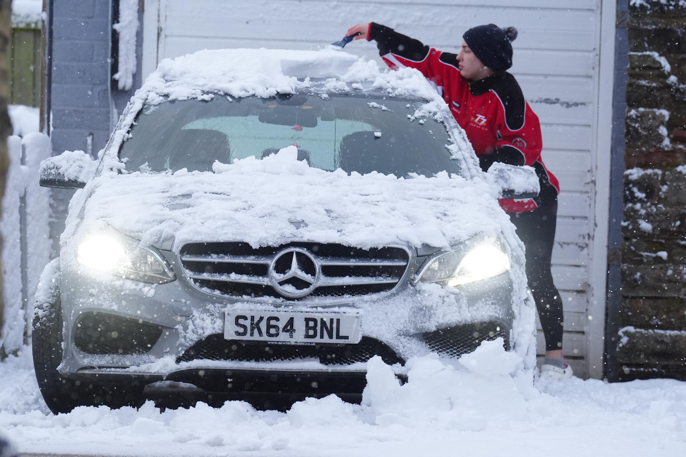 A person removing snow off their car in Tow Law, County Durham, on November 19, 2025. | Source: Getty Images