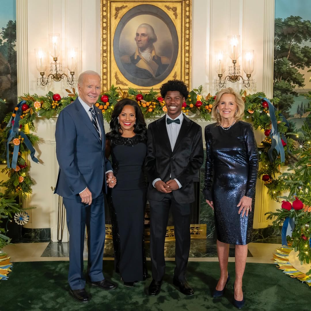 Sheinelle Jones, her son Kaylin Ojeh, former President Joe Biden and his wife, Jill, take photo in front of a beautifully decorated holiday display, from a post dated December 17, 2024. | Source: Instagram/sheinelle_o