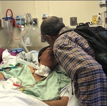 Picture of Luther Younger kissing his wife, Waverlee at the hospital | Source: Youtube/CBS News