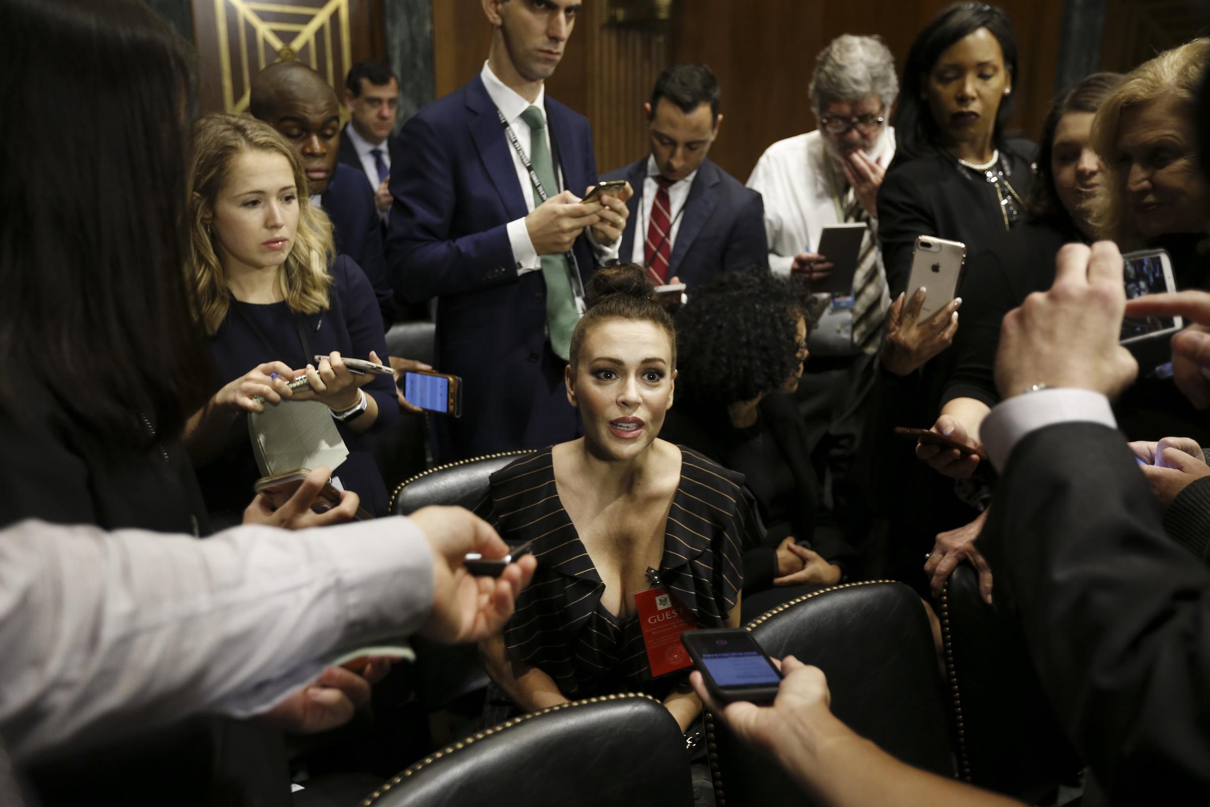 Alyssa Milano speaks to members of the media before the start of a Senate Judiciary Committee hearing in Washington, D.C., U.S., on September, 27, 2018. | Source: Getty Images