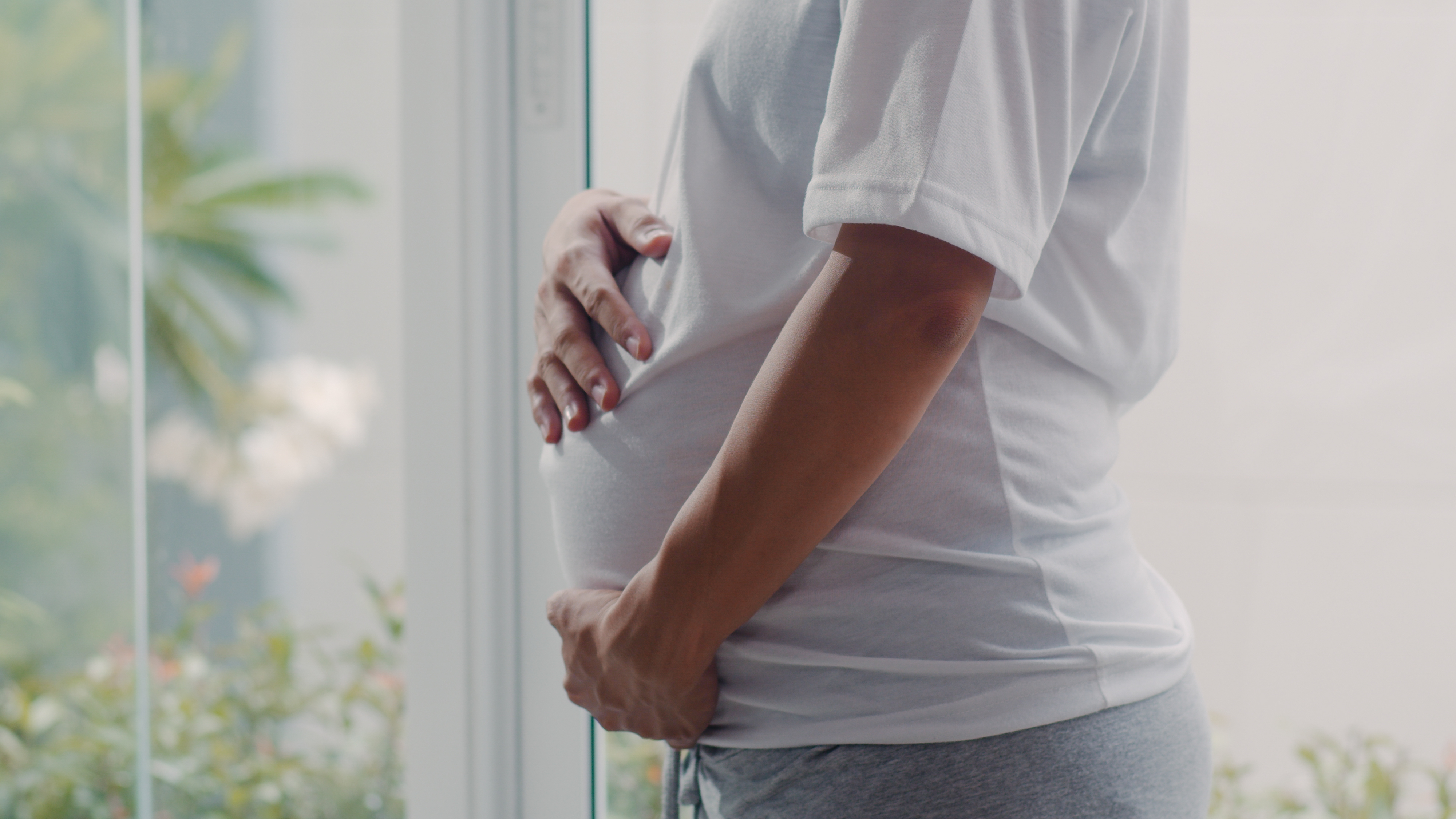 A pregnant woman holding her belly | Source: Shutterstock