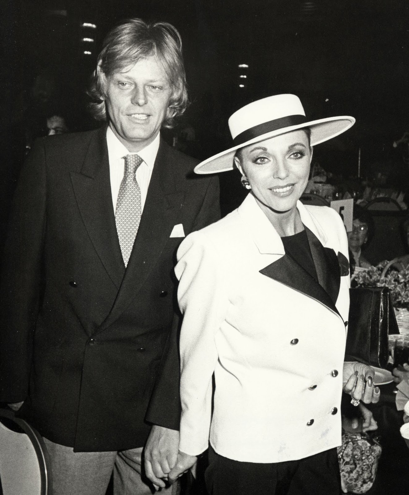 In 1983, Joan Collins attended the Young Musicians Annual Celebrity Mother-Daughter Fashion Show Luncheon with Peter Holm. Their relationship was highly scrutinized, eventually ending in a turbulent divorce that would outlast the marriage itself. | Source: Getty Images