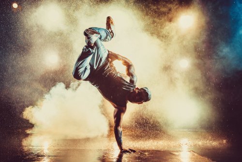 A young man breakdancing in a club. | Source: Shutterstock. A young man breakdancing in a club. | Source: Shutterstock.