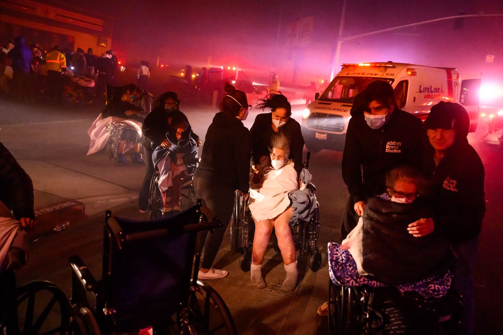 Elderly patients being evacuated into emergency vehicles as embers and flames approach during the Eaton fire in Pasadena, California, on January 7, 2025. | Source: Getty Images