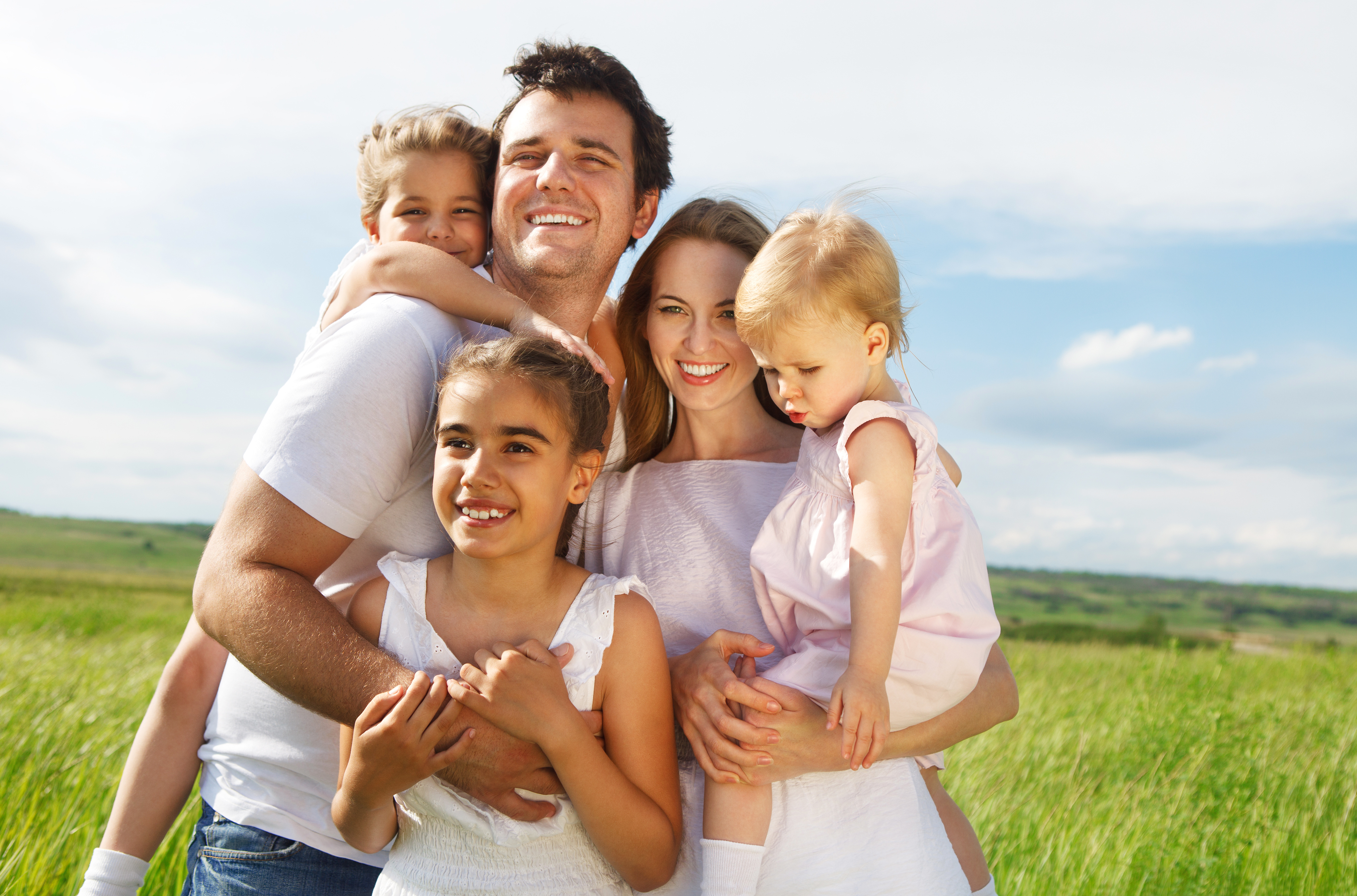 A couple with three children outdoors | Source: Shutterstock