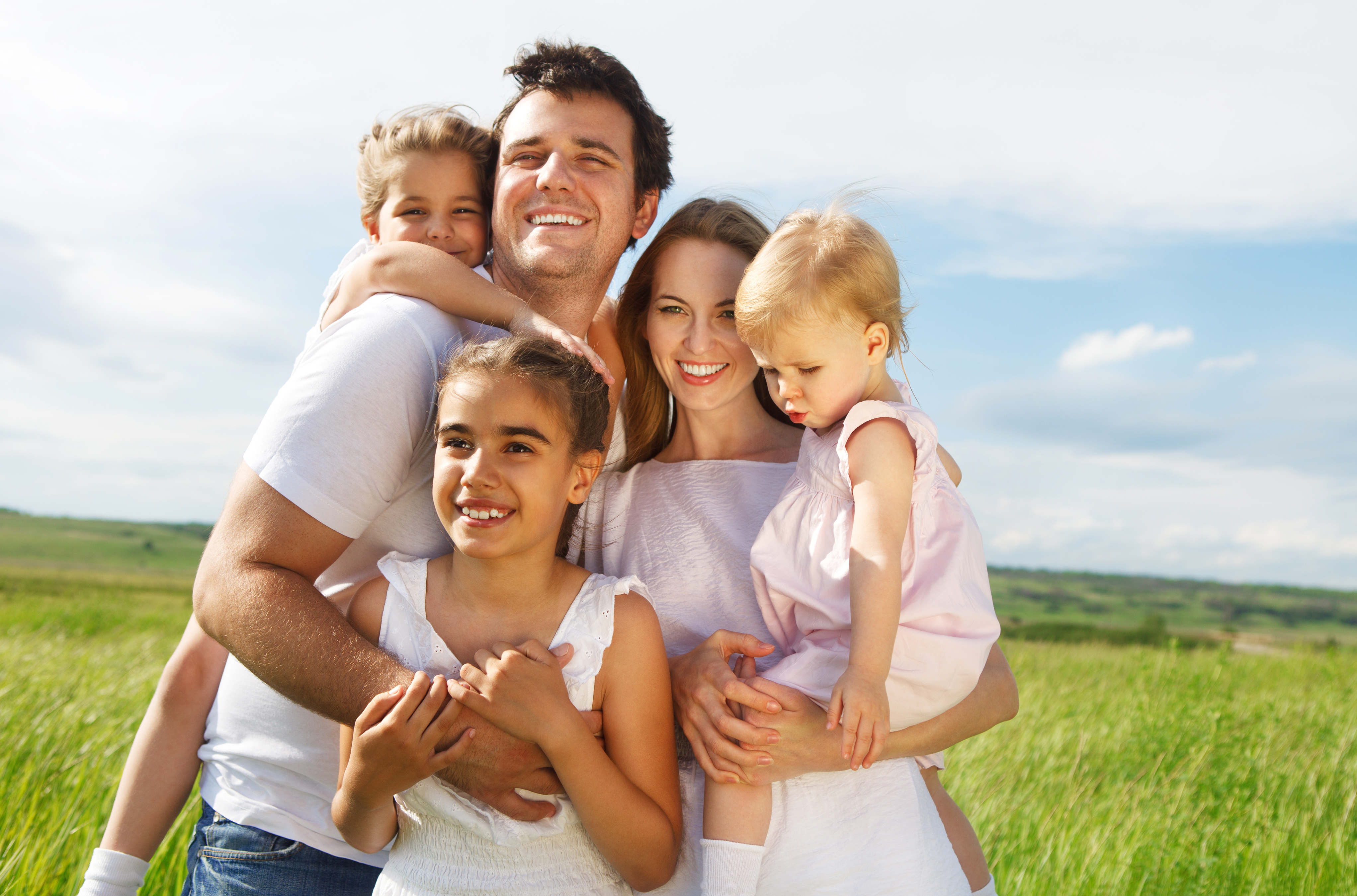 Happy parents with three children outdoors | Source: Shutterstock