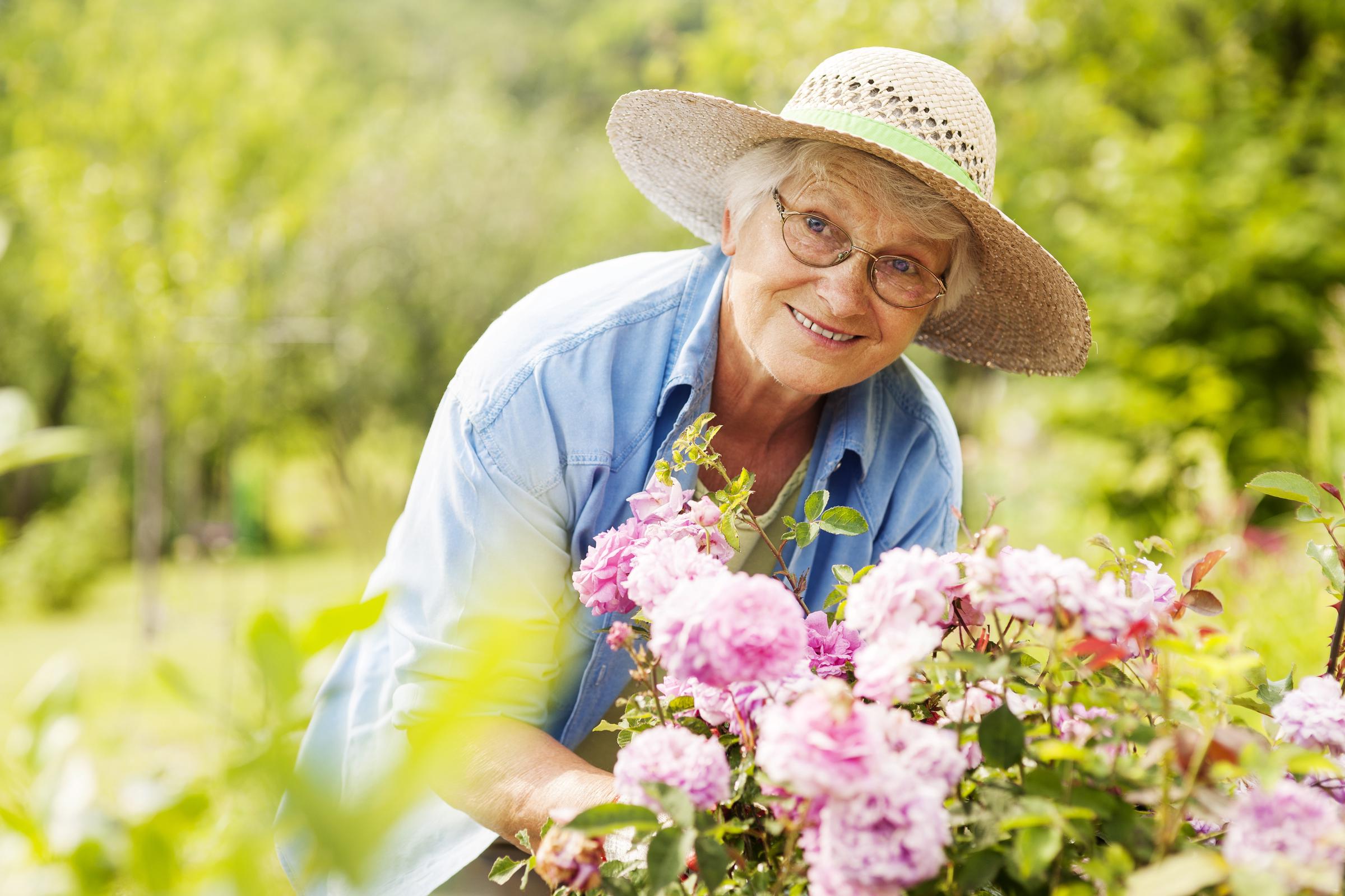 An older woman in her garden | Source: Freepik