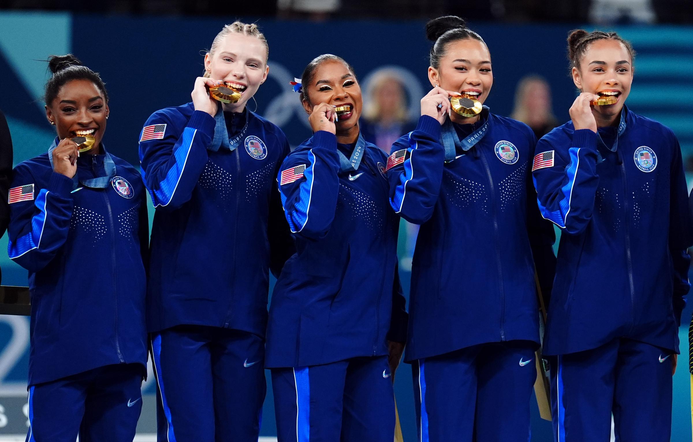 (L-R) Simone Biles, Jade Carey, Jordan Chiles, Sunisa Lee and Hezly Rivera pose with their gold medals at the 2024 Paris Olympic Games on July 30, 2024, in Paris, France. | Source: Getty Images