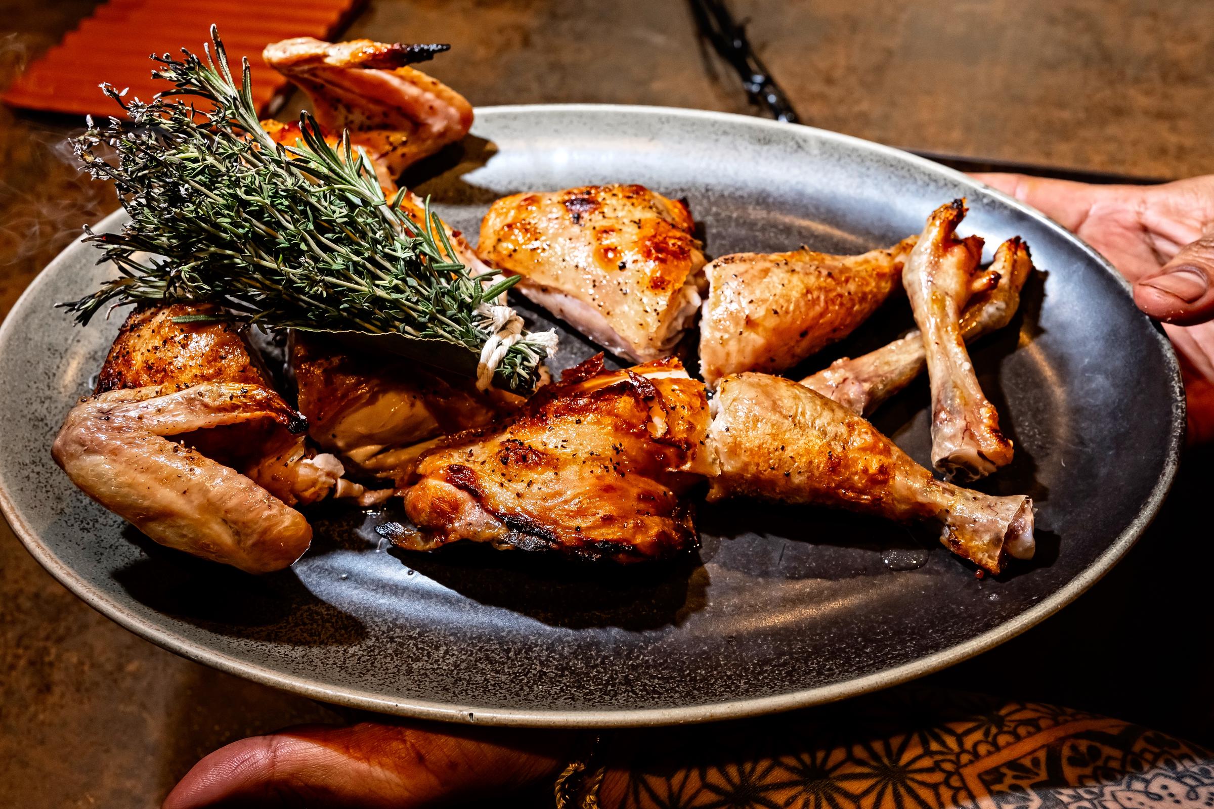 Grilled chicken pieces sitting on a plate at Casa Teresa Restaurant in Washington, D.C., on December 21, 2023. | Source: Getty Images