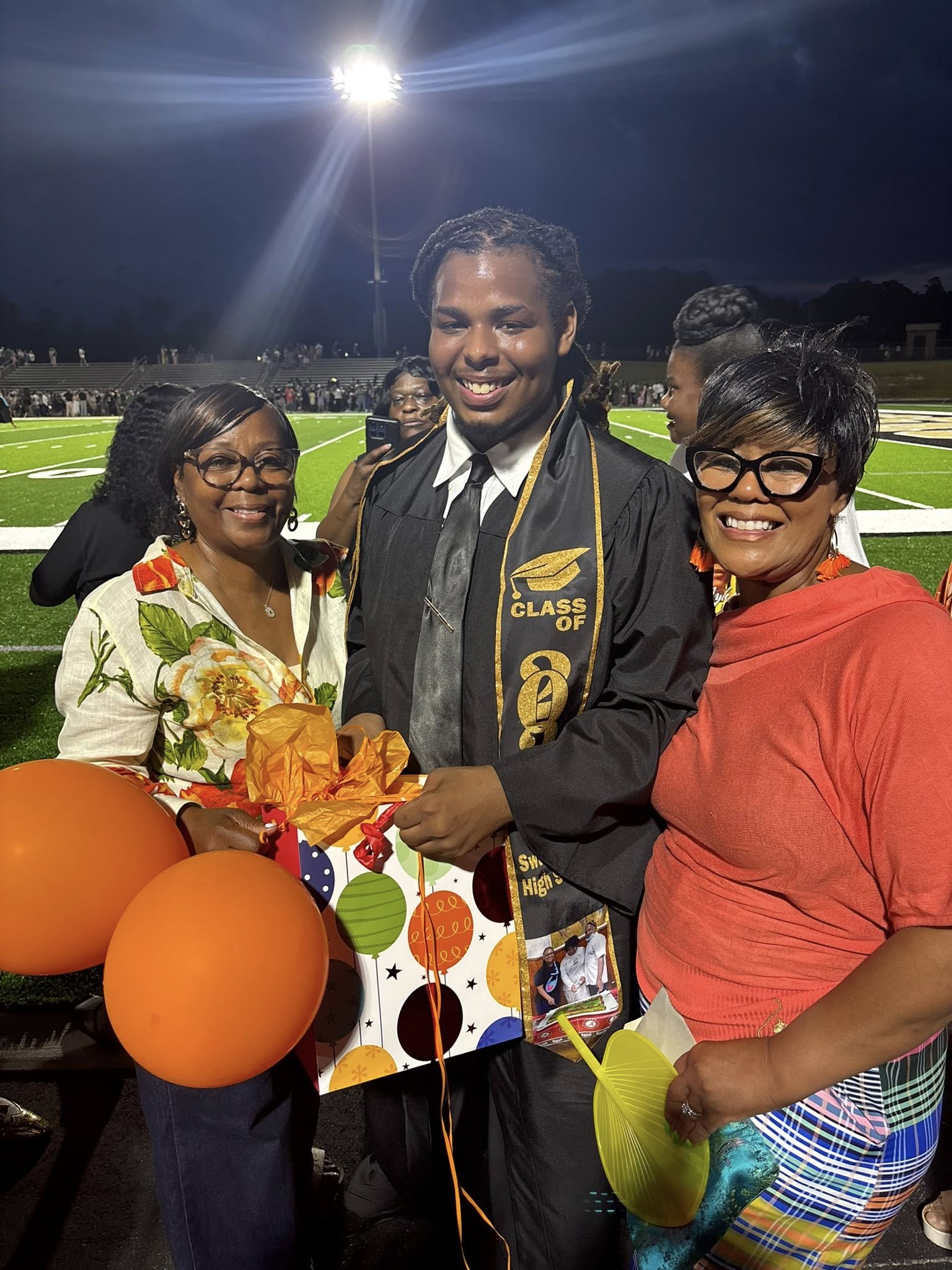 Kencerio Walker and his family looking happy during his graduation on May 22, 2026 | Source: Facebook/Lisa Kennedy