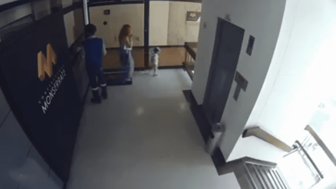 Captura del video de las cámaras de seguridad. La madre se distrae con el celular mientras su bebé se aleja de ella. | Fuente: Facebook / Guardianes De Antioquia Captura del video de las cámaras de seguridad. La madre se distrae con el celular mientras su bebé se aleja de ella. | Fuente: Facebook / Guardianes De Antioquia