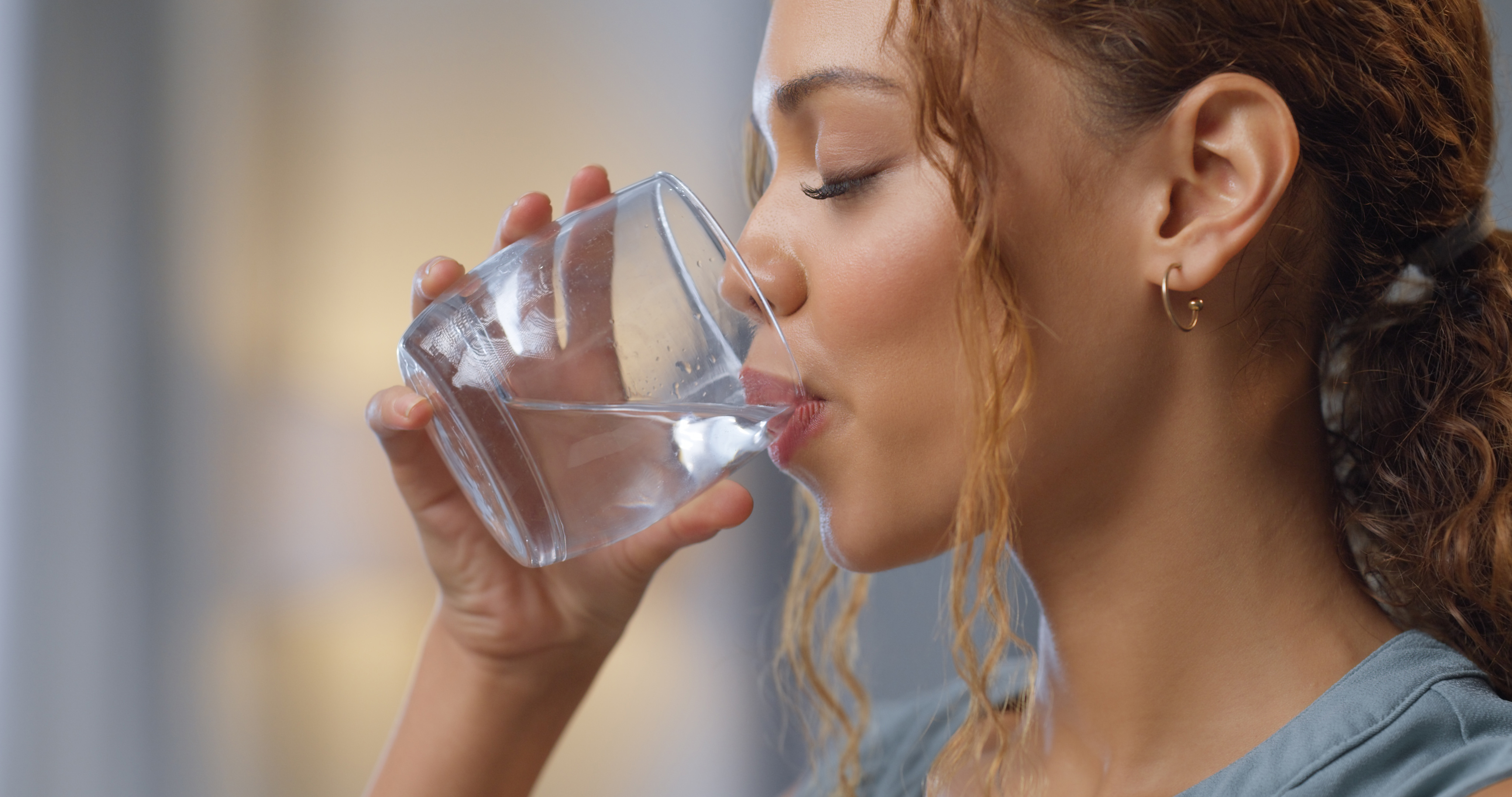 A woman enjoying a glass of water | Source: Getty Images