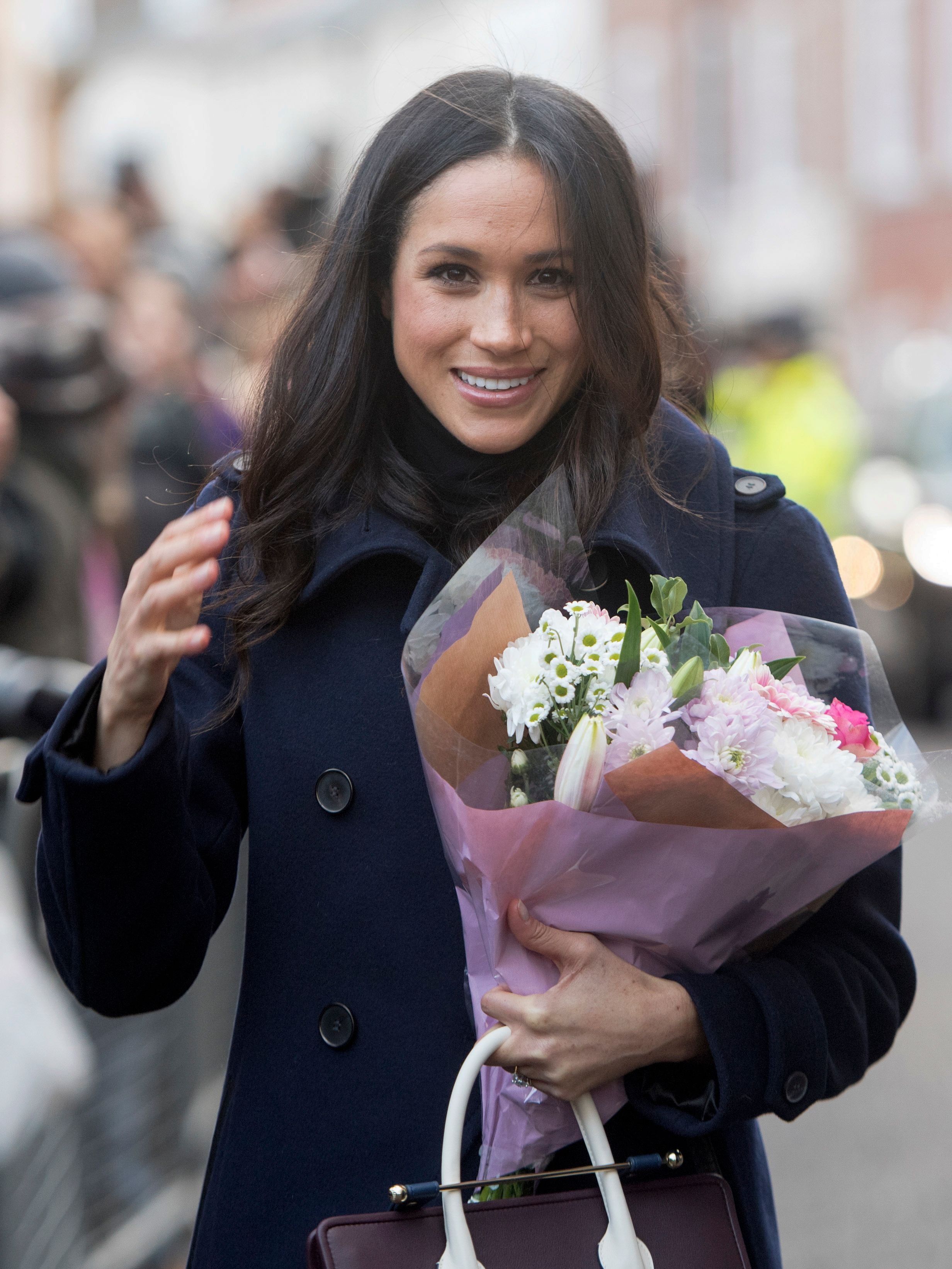 Meghan Markle greets wellwishers on a walkabout as they arrive for an engagement at Nottingham Contemporary in Nottingham, central England, on December 1, 2017, which is hosting a Terrence Higgins Trust World AIDS Day charity fair. | Source: Getty Images