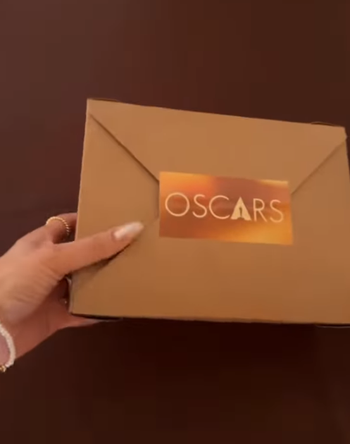 A sleek brown box stamped with a gold “Oscars” label is held up. | Source: Instagram/instylemagazine
