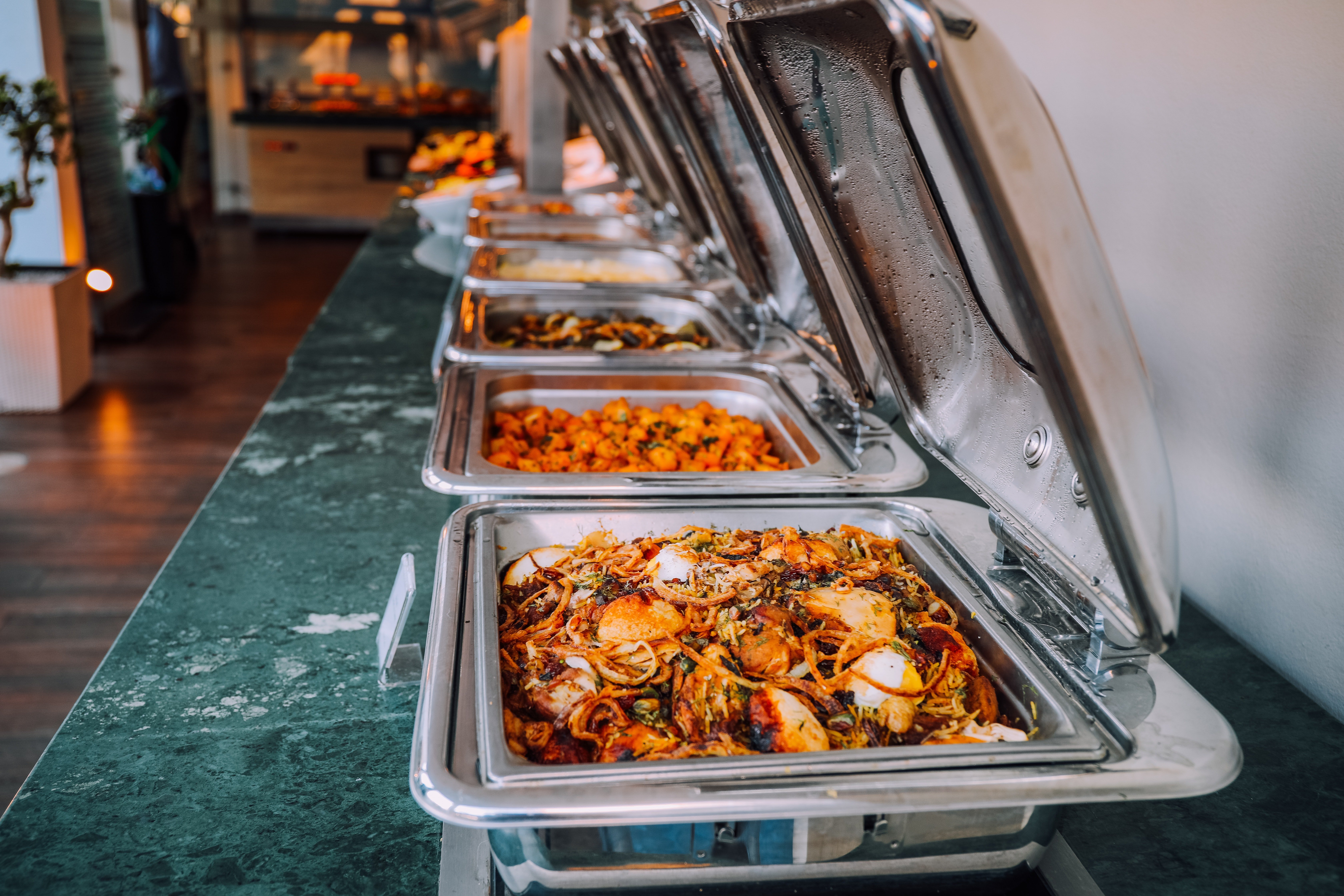 Jessica decided to get some food for the old man from the buffet, hoping it would get him to leave. | Source: Pexels