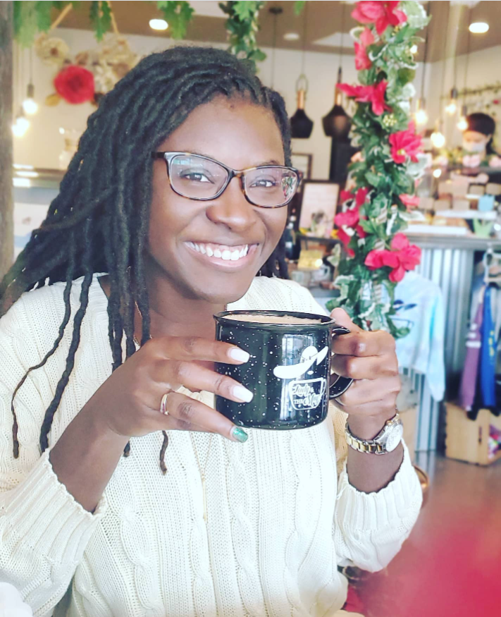 Smiling warmly in a cozy café setting, Nancy Metayer Bowen holds a mug close, her relaxed posture and soft lighting capturing a peaceful, everyday moment. | Source: Instagram/nancymetayerbowen