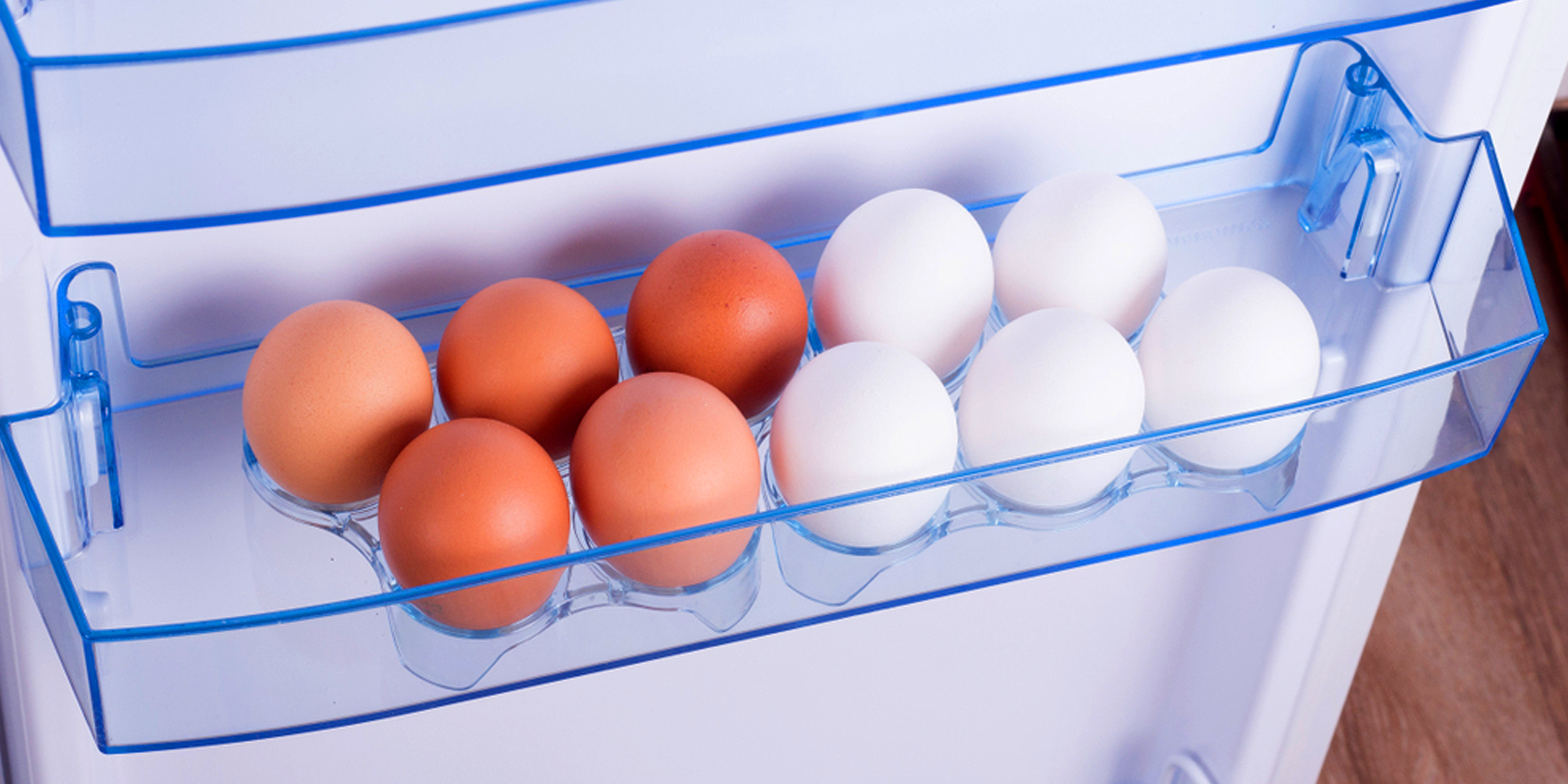 Pieces of eggs on the shelf of an open fridge | Source: Shutterstock