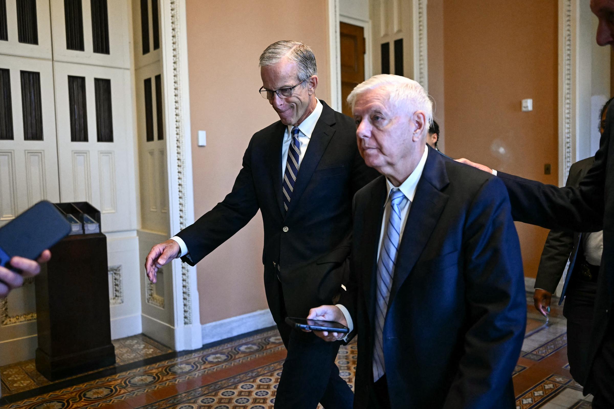 Lindsey Graham walks through the U.S. Capitol with Senate Majority Leader John Thune during the final weeks of his Senate service. The medical examiner has emphasized that the reported cause of death is preliminary and could be updated after routine toxicological and microscopic testing is complete. | Source: Getty Images