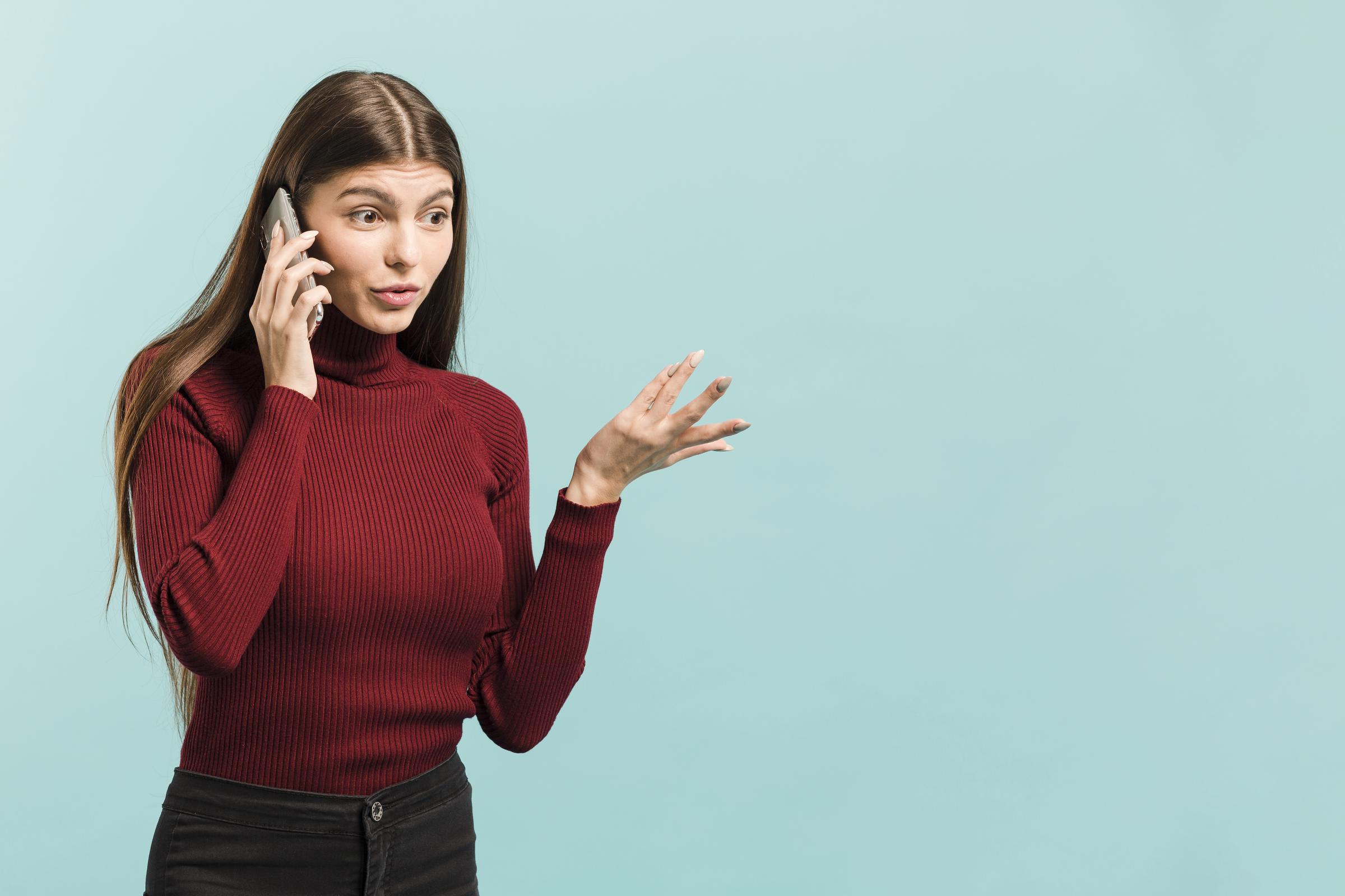 A woman on a call gesturing with her hand | Source: Freepik