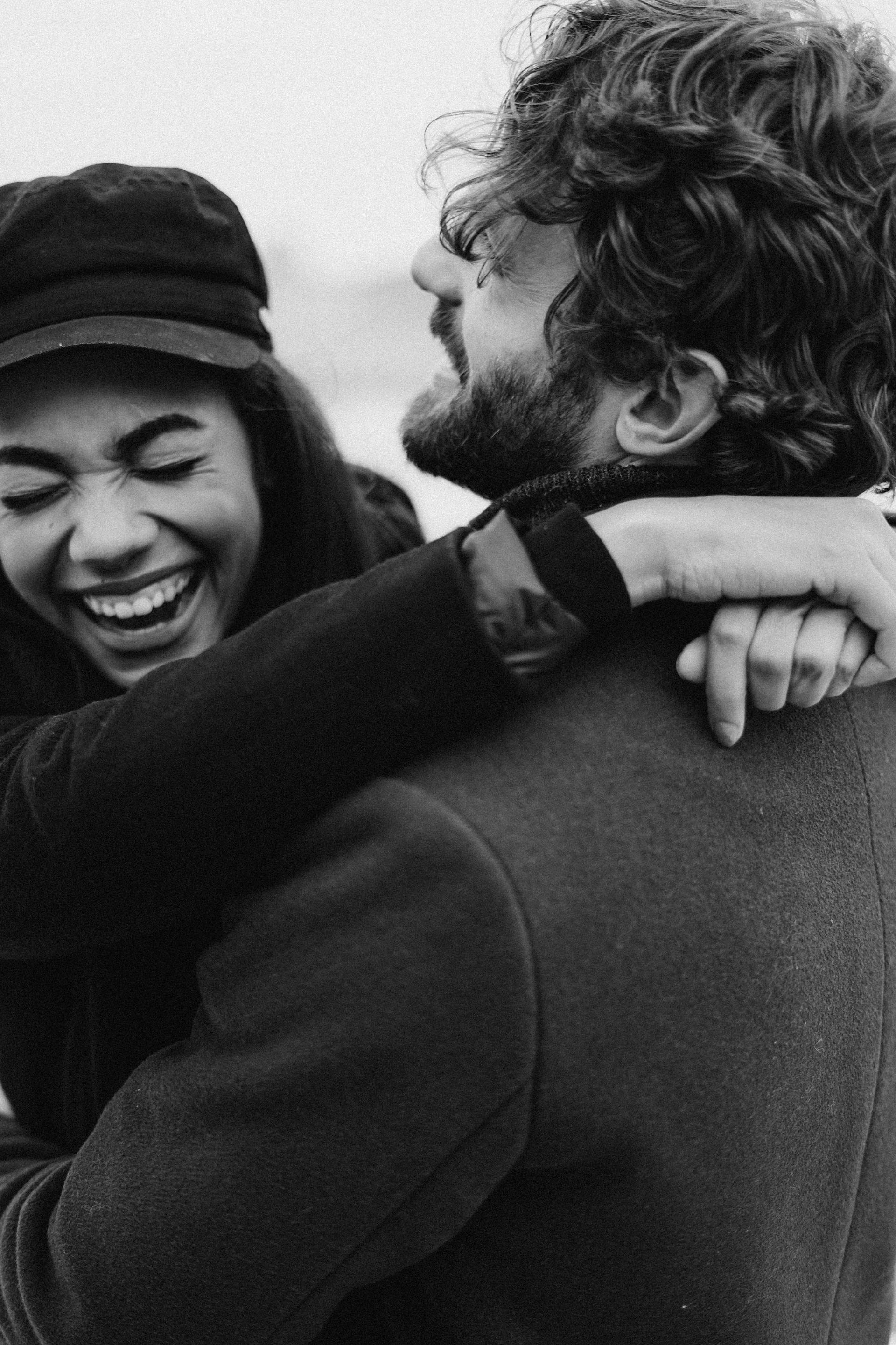 A monochrome photo of a couple laughing | Source: Pexels