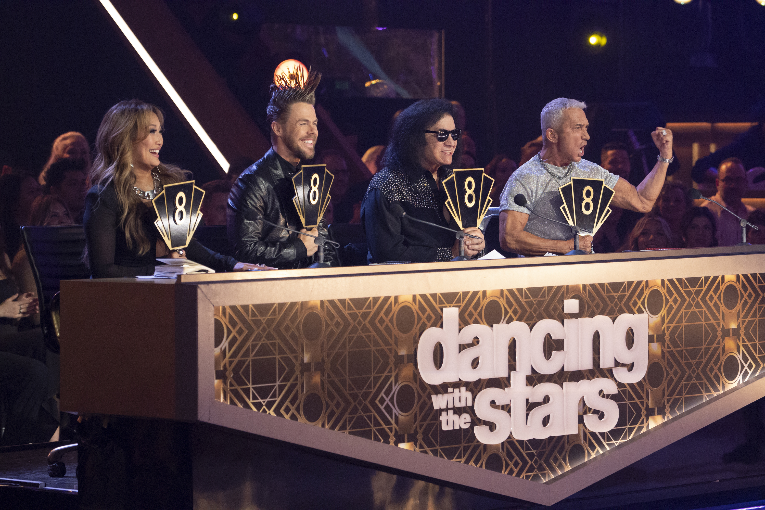 Carrie Ann Inaba, Derek Hough, Gene Simmons, and Bruno Tonioli giving contestants scores. | Source: Getty Images