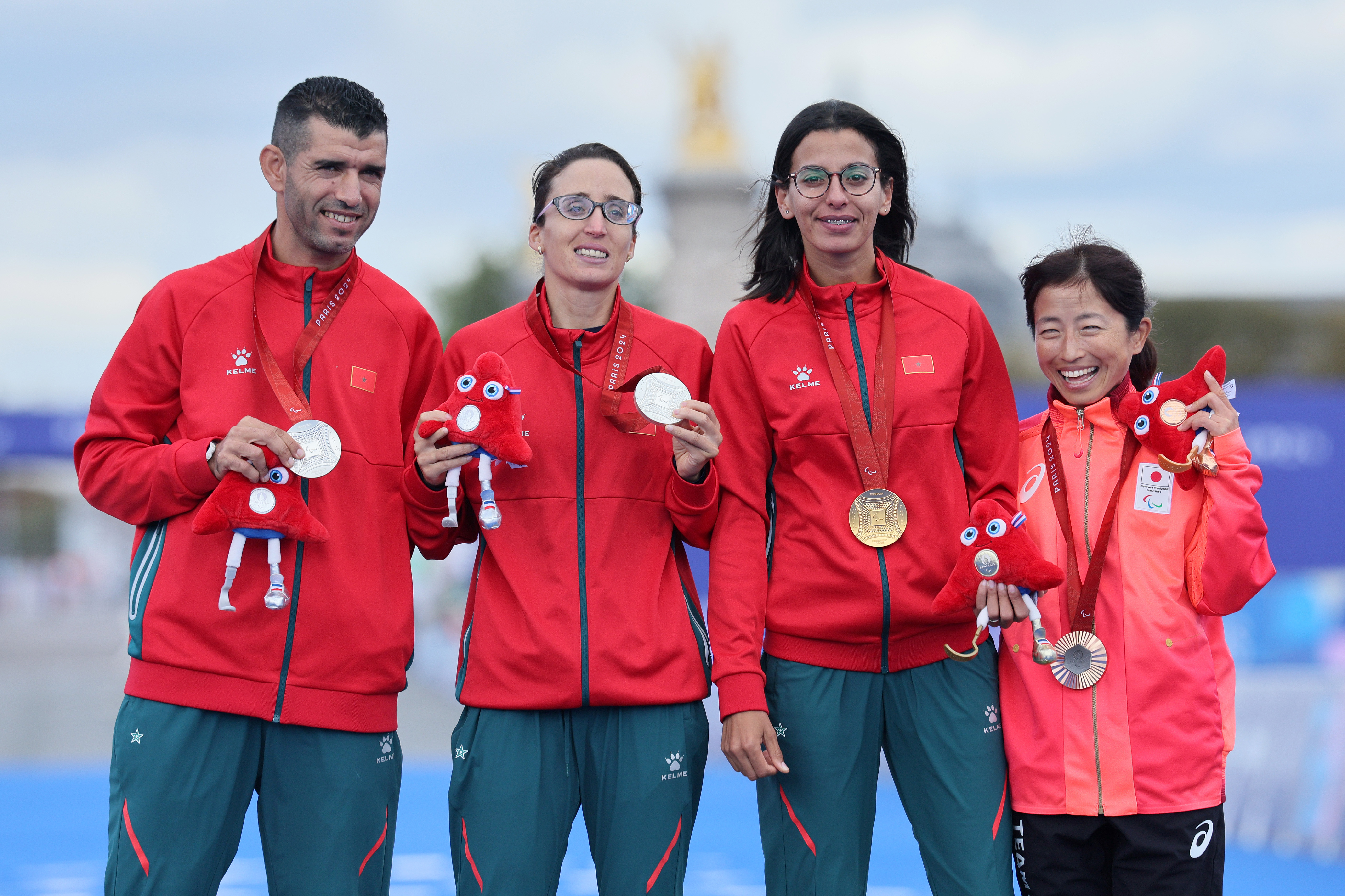 Fatima Ezzahra El Idrissi and Meryem En-Nourhi with her guide Abdelhadi El Harti and Misato Michishita of Team Japan during the Women's T12 Marathon medal ceremony at the Paris 2024 Summer Paralympic Games in Paris, France on September 8, 2024 | Source: Getty Images