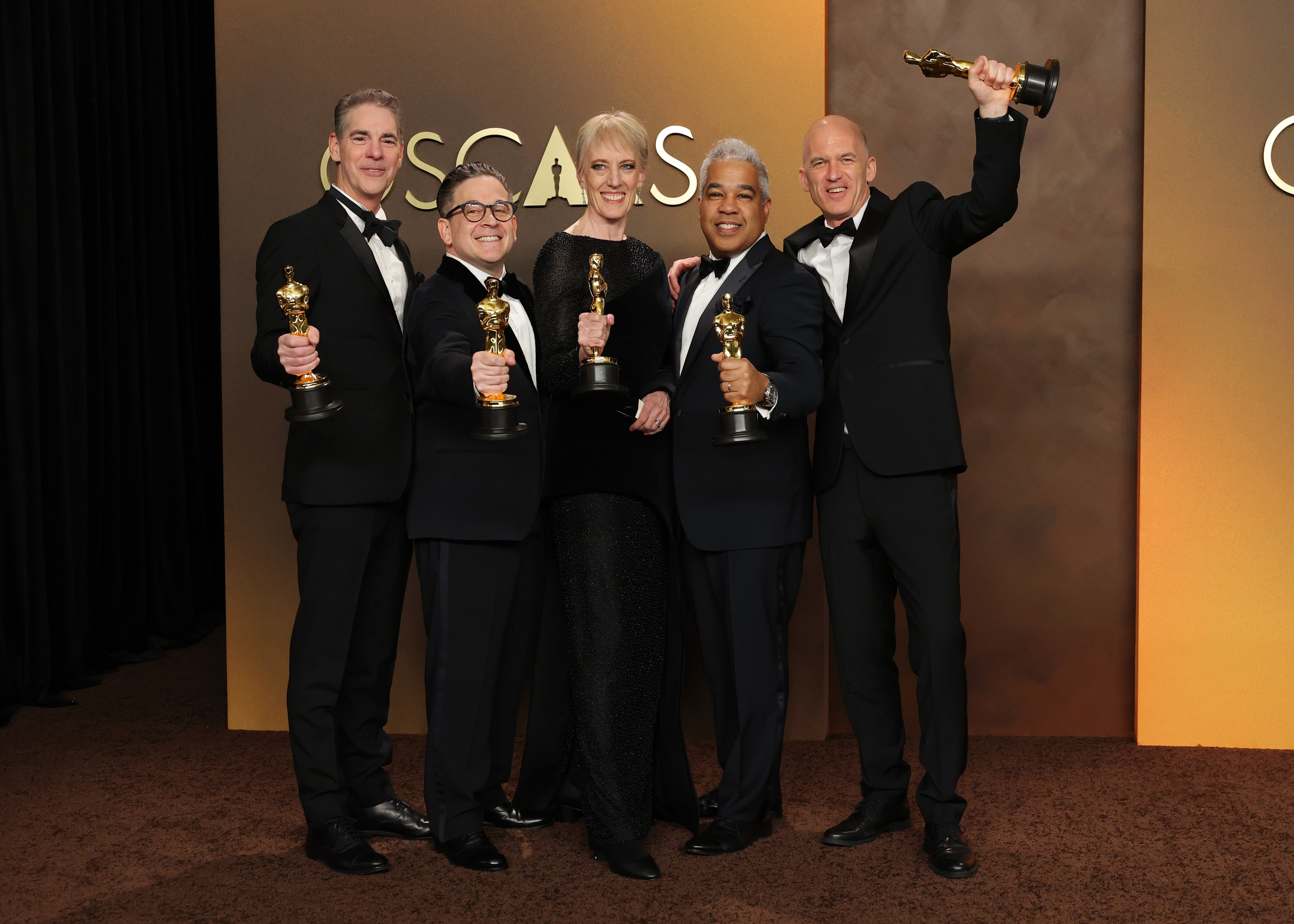 (L-R) Al Nelson, Gareth John, Gwendolyn Yates Whittle, Gary Rizzo and Juan Peralta, winners of the Best Sound Award for "F1", pose in the press room during the 98th Oscars at Dolby Theatre on 15 March 2026 in Hollywood, California. | Source: Getty Images