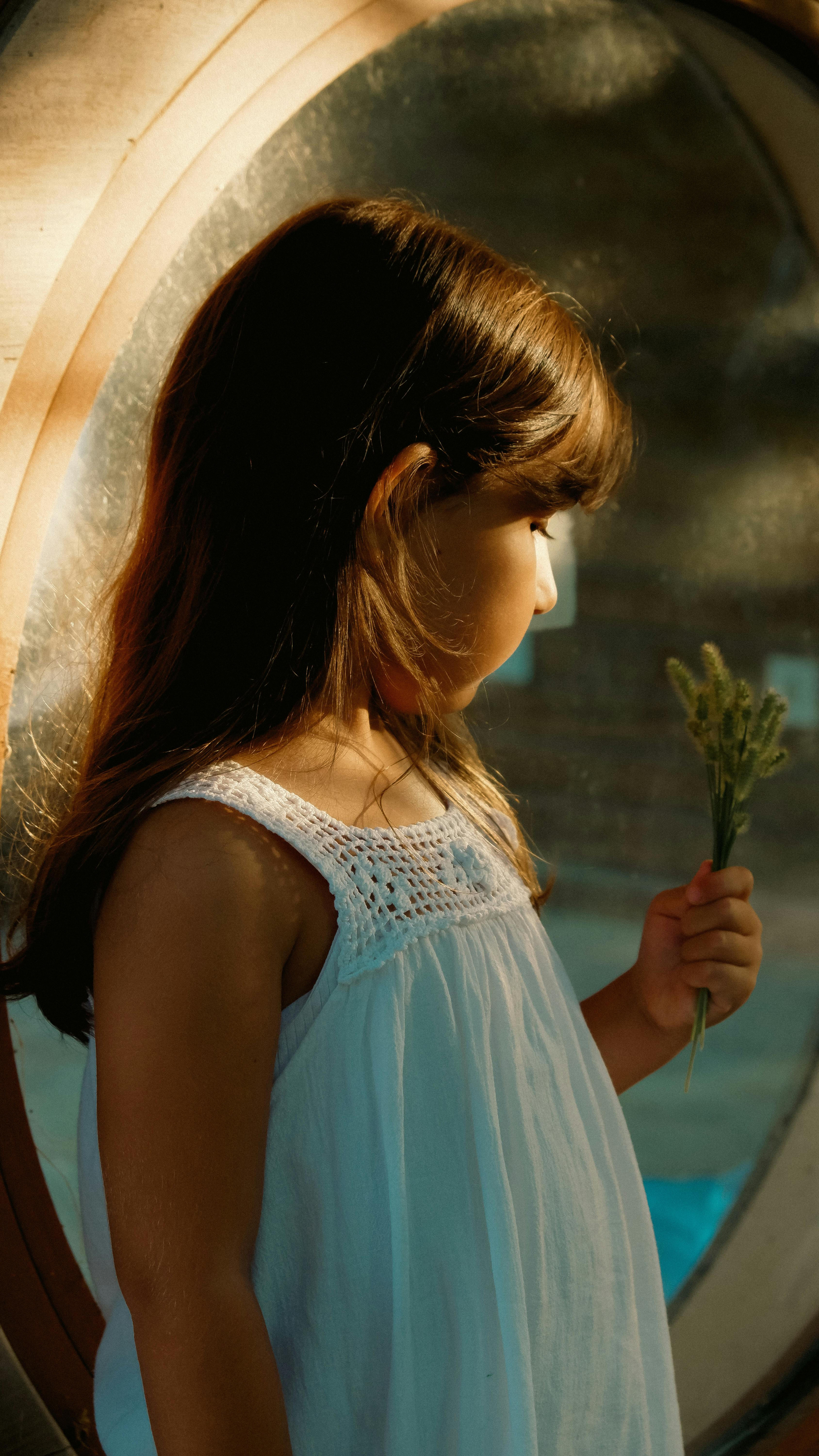 A girl by the window | Source: Pexels