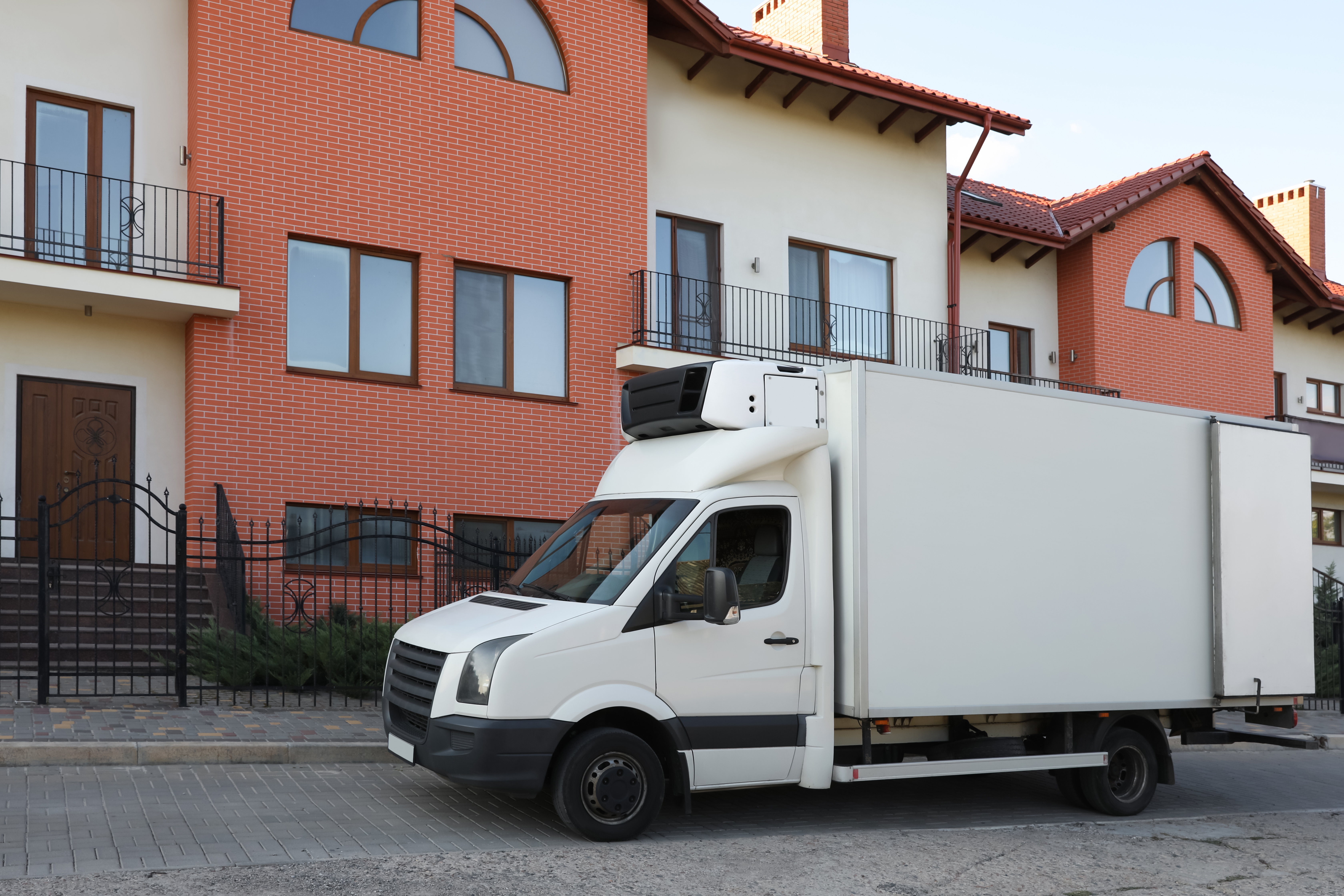 White van near new house. Moving service. | Source: Shutterstock