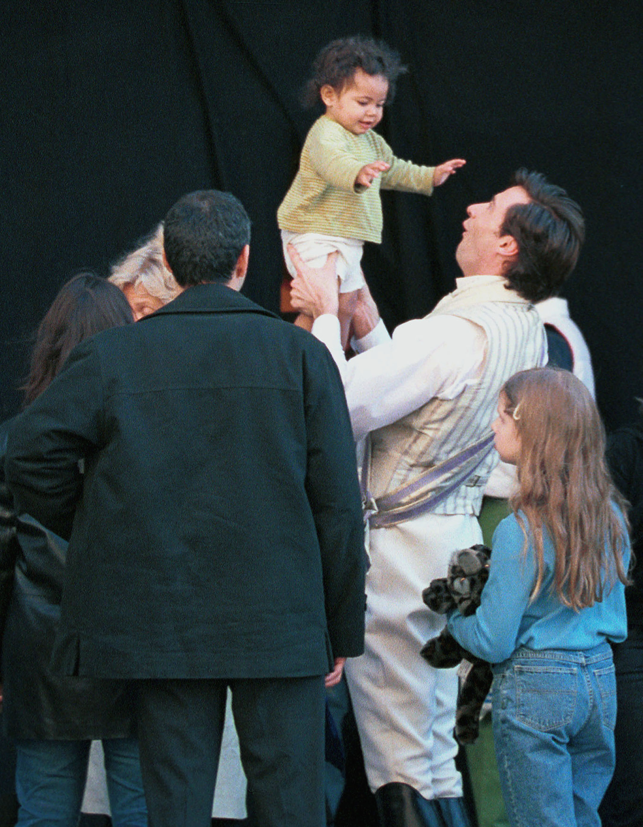 Hugh Jackman plays with Oscar Maximilian on the movie set of "Kate and Leopold" in New York City on April 5, 2001 | Source: Getty Images
