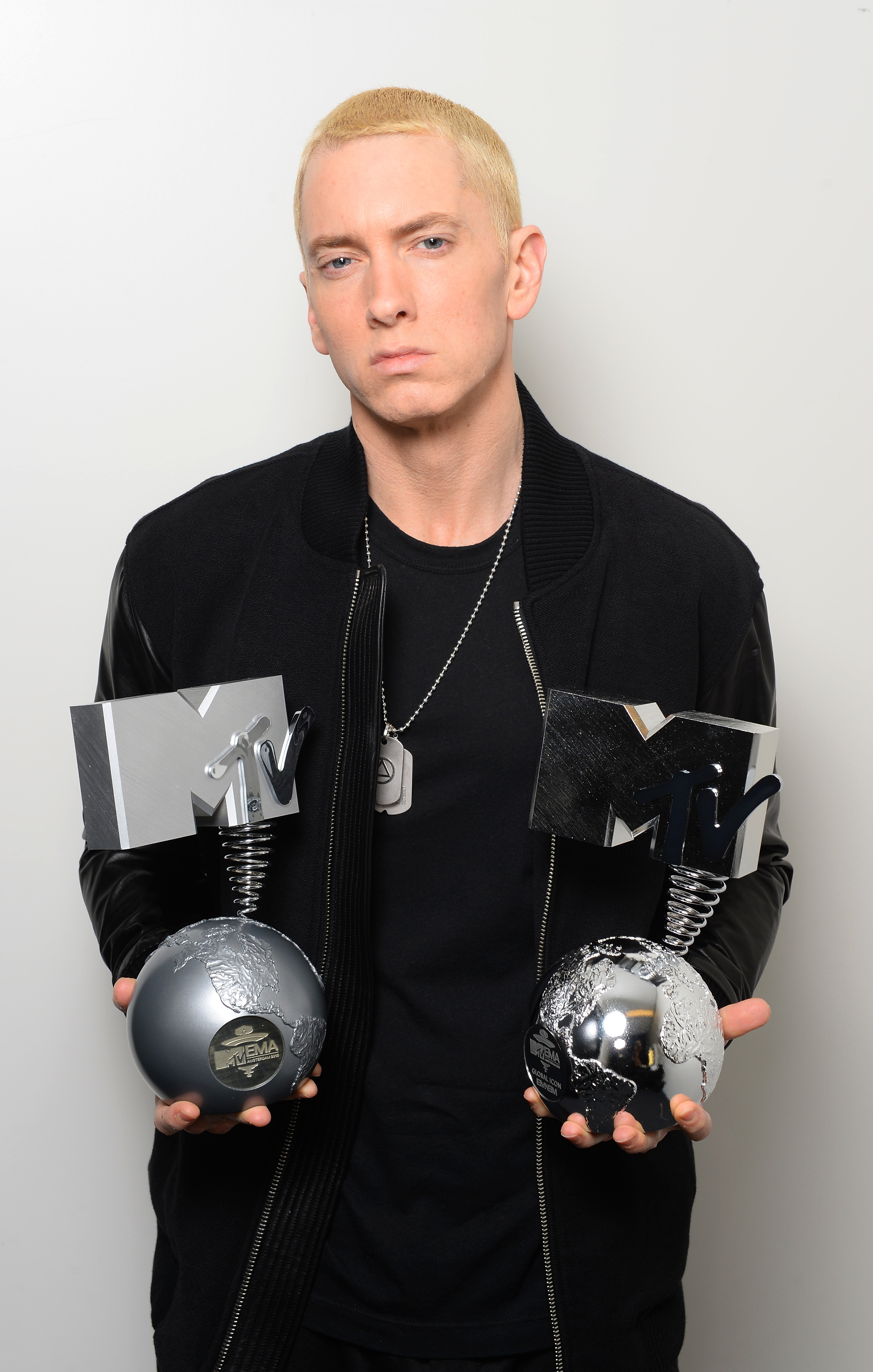 Eminem poses in his dressing room with the "Best Hip Hop" and "Global Icon" awards on November 10, 2013, in Amsterdam, Netherlands. | Source: Getty Images