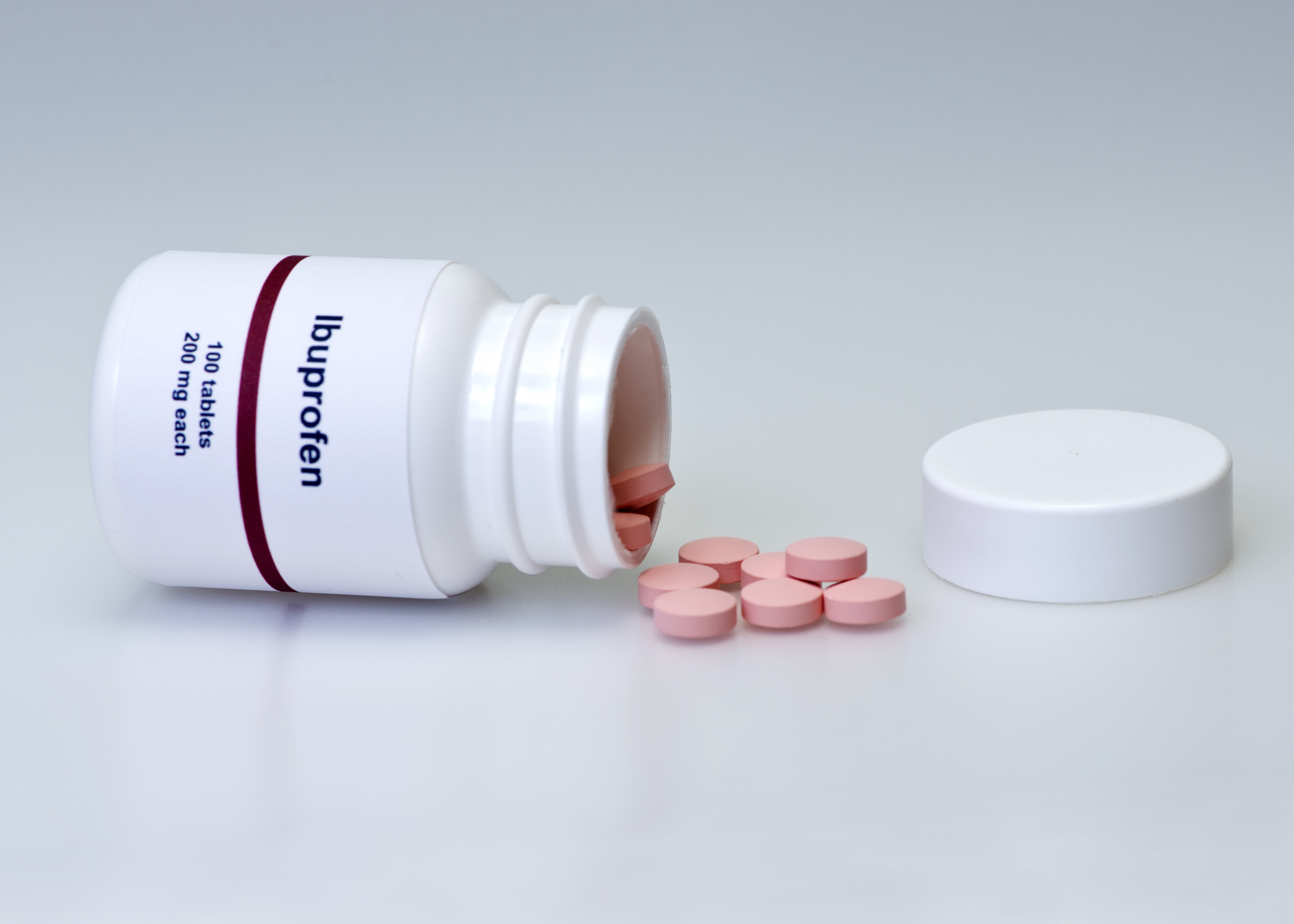 Ibuprofen bottle and tablets. Label is not real | Photo: Shutterstock.com