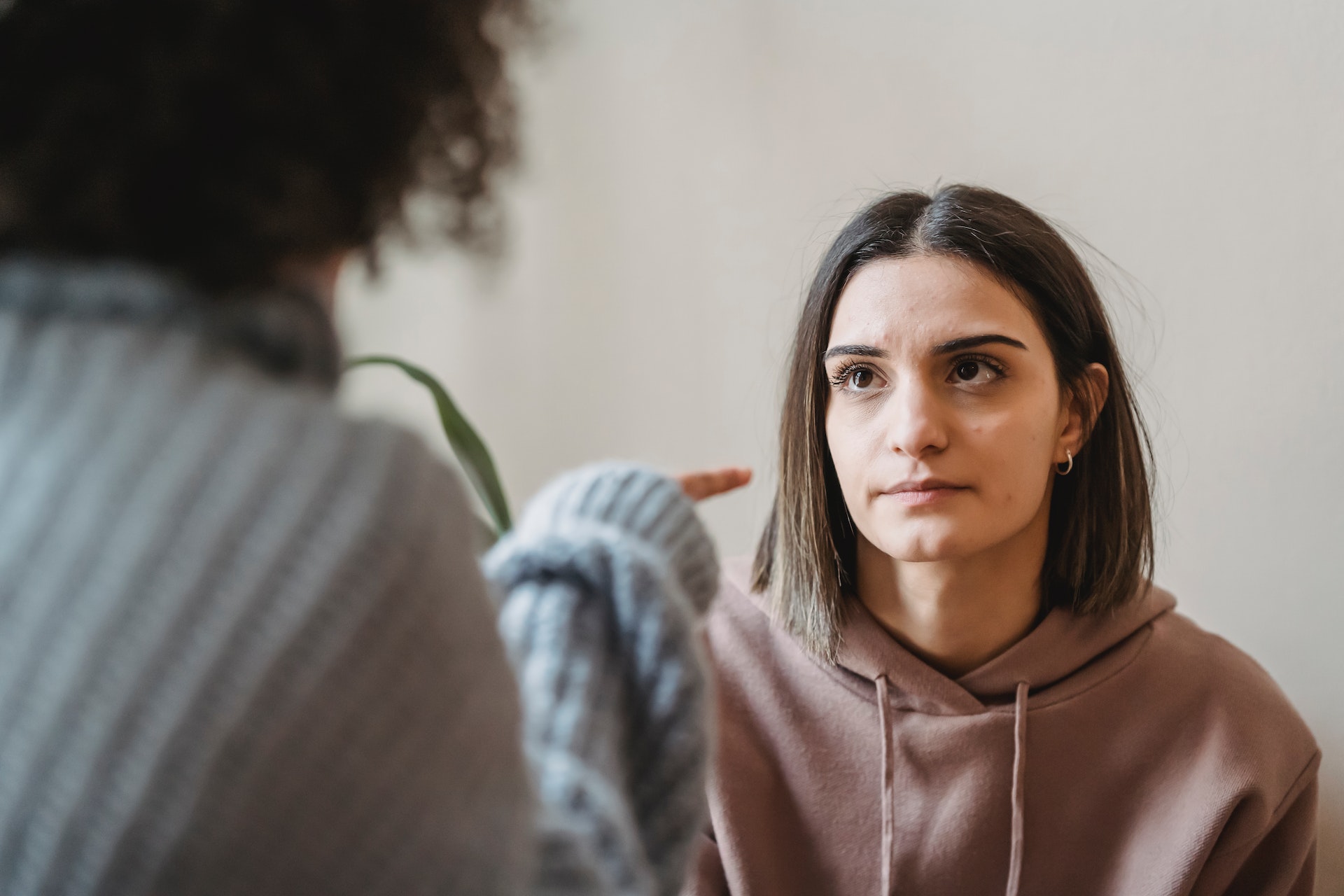 A woman looking at another woman talking to her | Source: Pexels