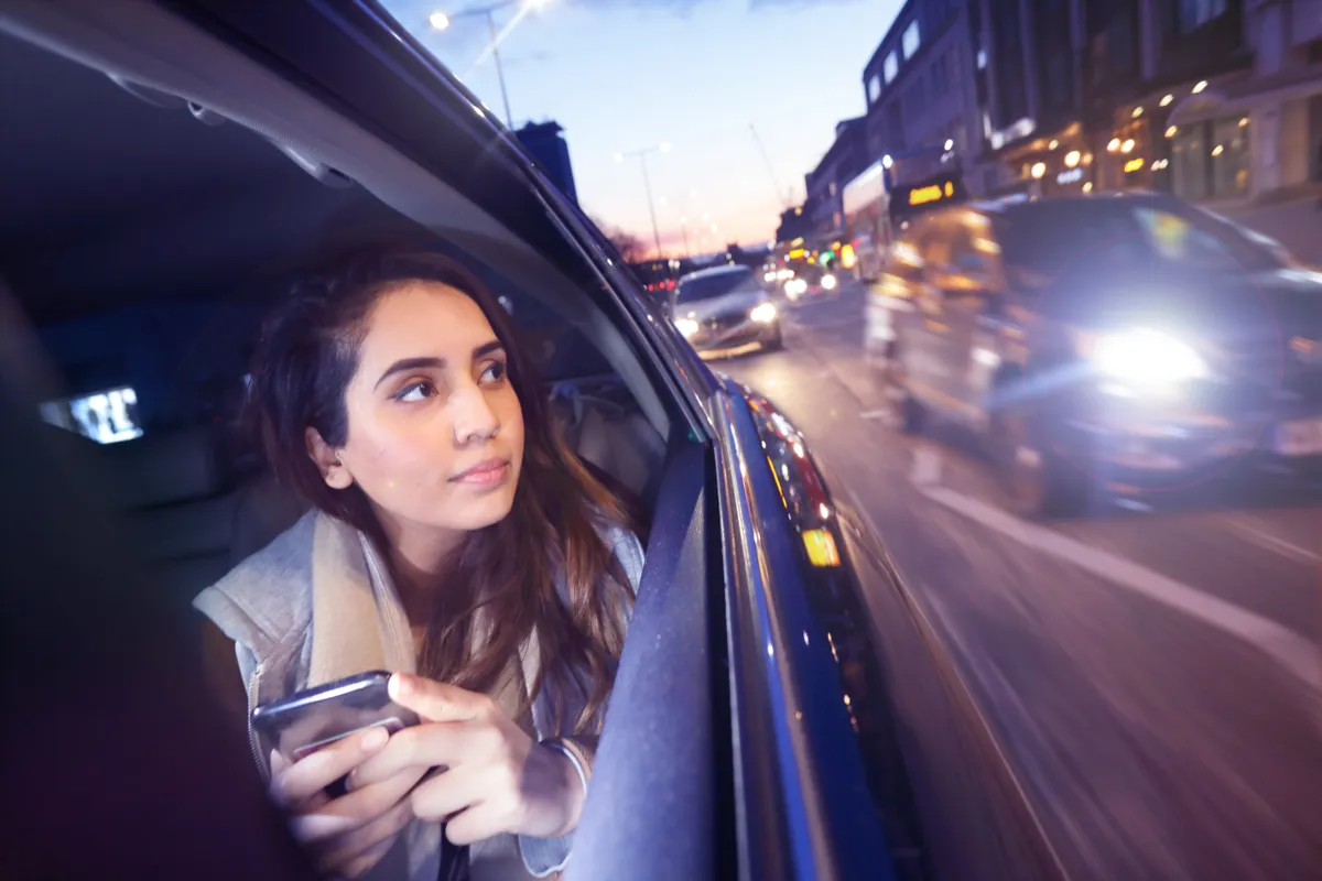 A woman looking outside from the car window | Source: Getty Images