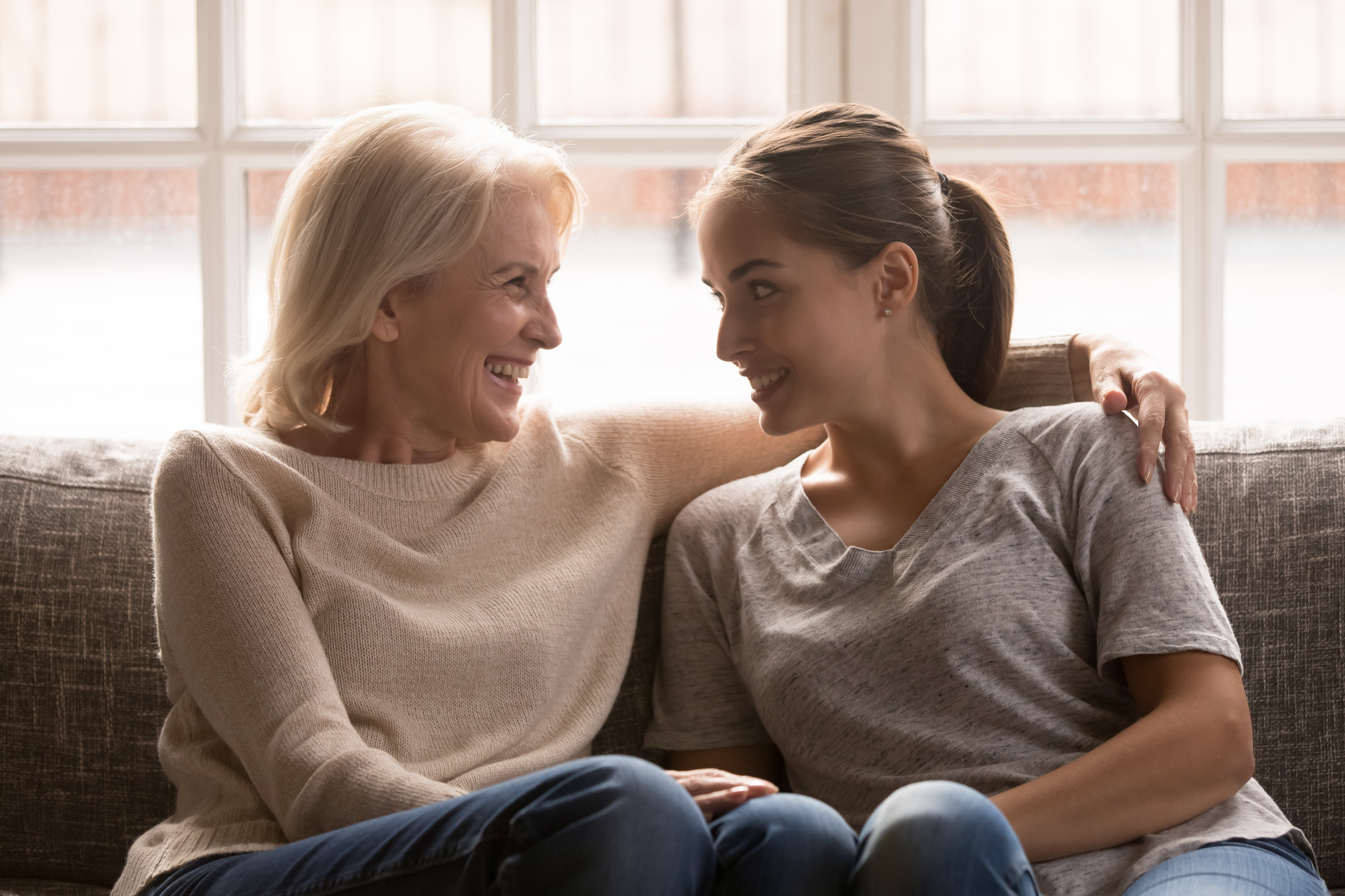 An older woman and a younger woman smiling at each other | Source: Shutterstock
