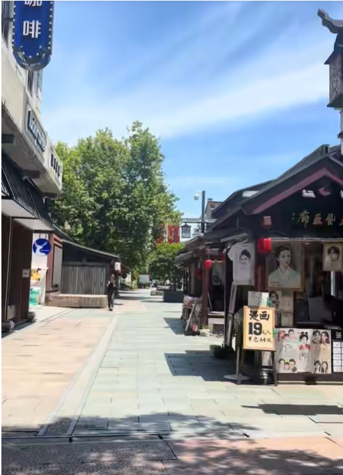 Before the video ends, it shows a pedestrian shopping street in Hangzhou lined with traditional-style storefronts, signs, and trees beneath a clear blue sky. | Source: TikTok/mandykarolk