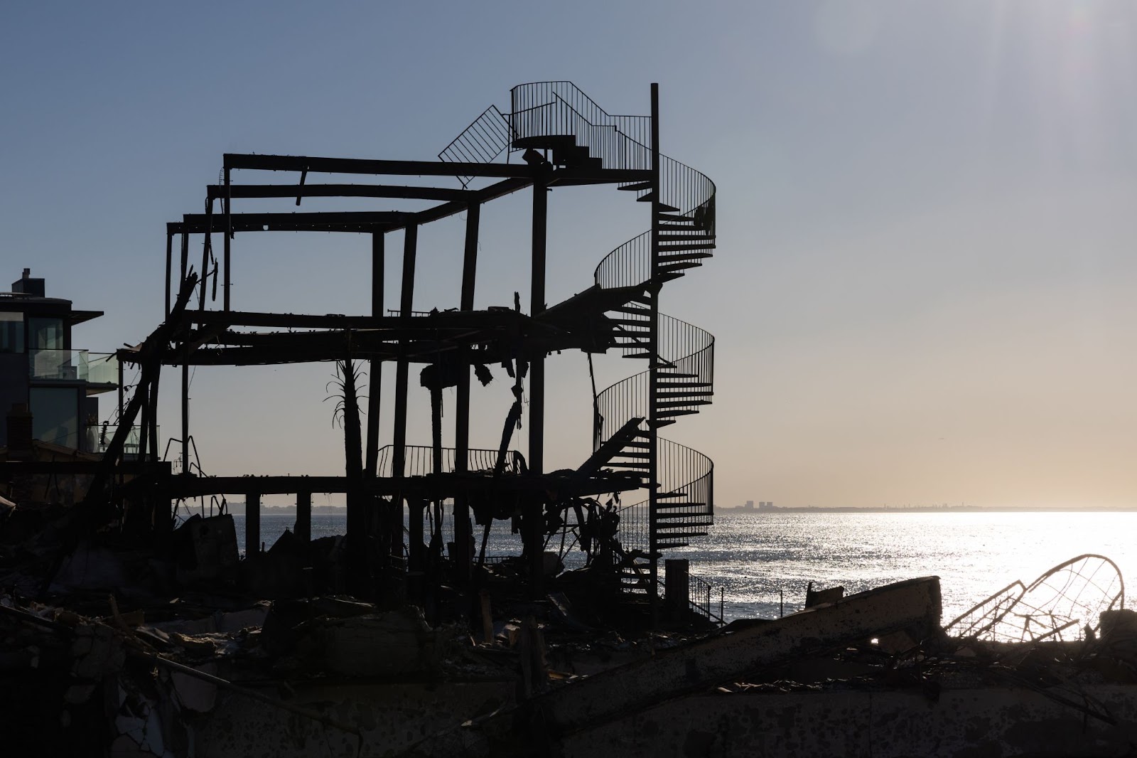 A spiral staircase among scorched debris after the wildfires on January 12, 2025, in Los Angeles, California. | Source: Getty Images