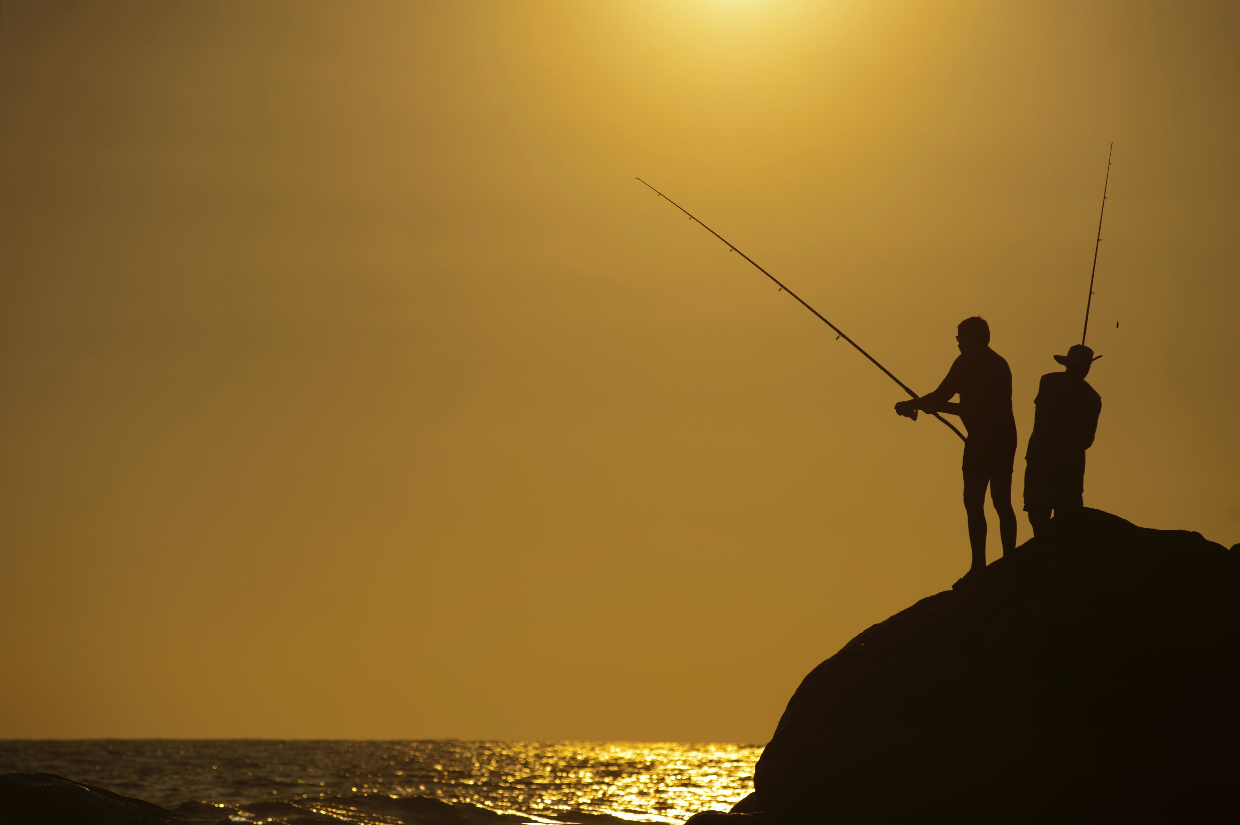Two men fishing. | Source: Pexels