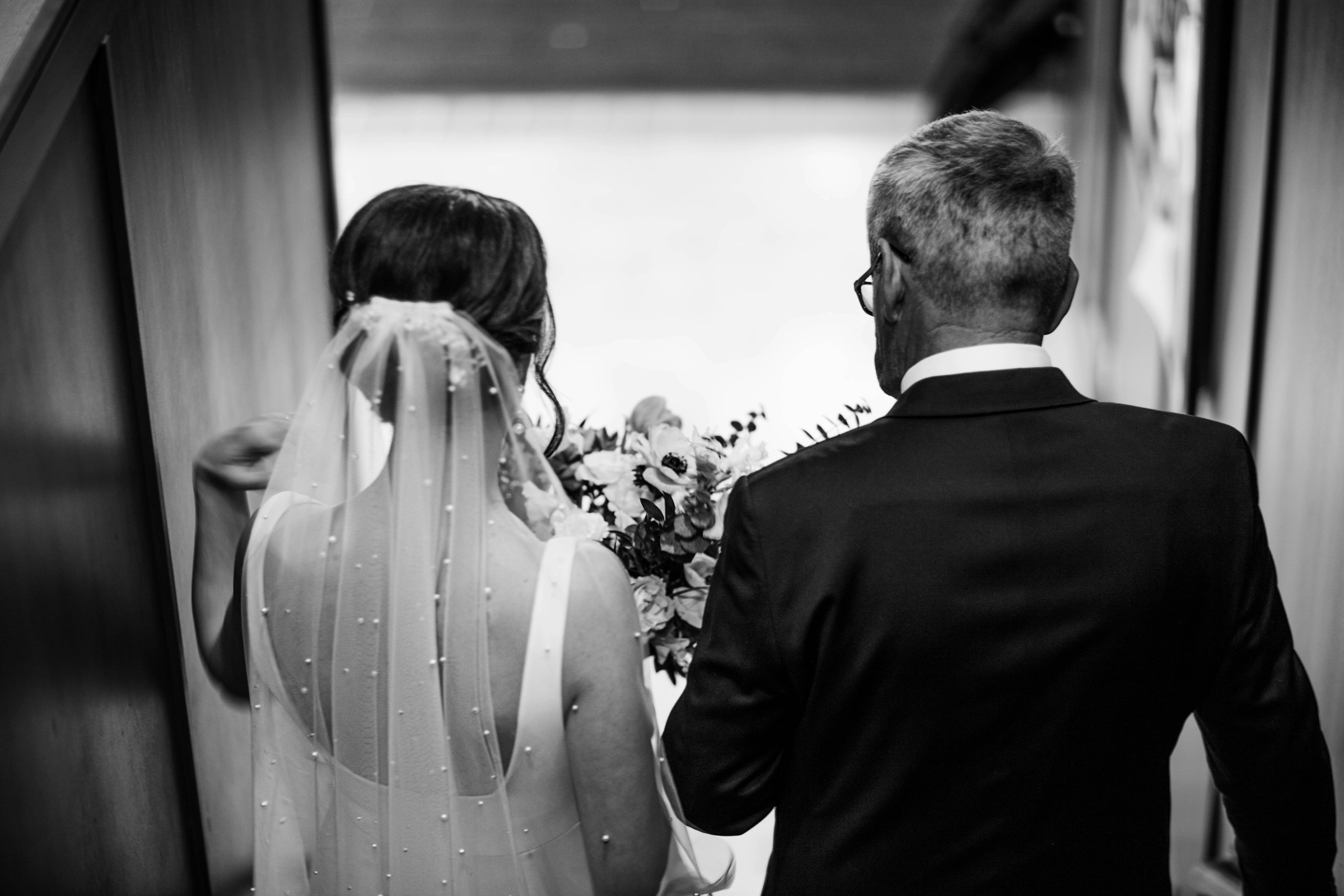 A father and bride walking down a hallway | Source: Unsplash