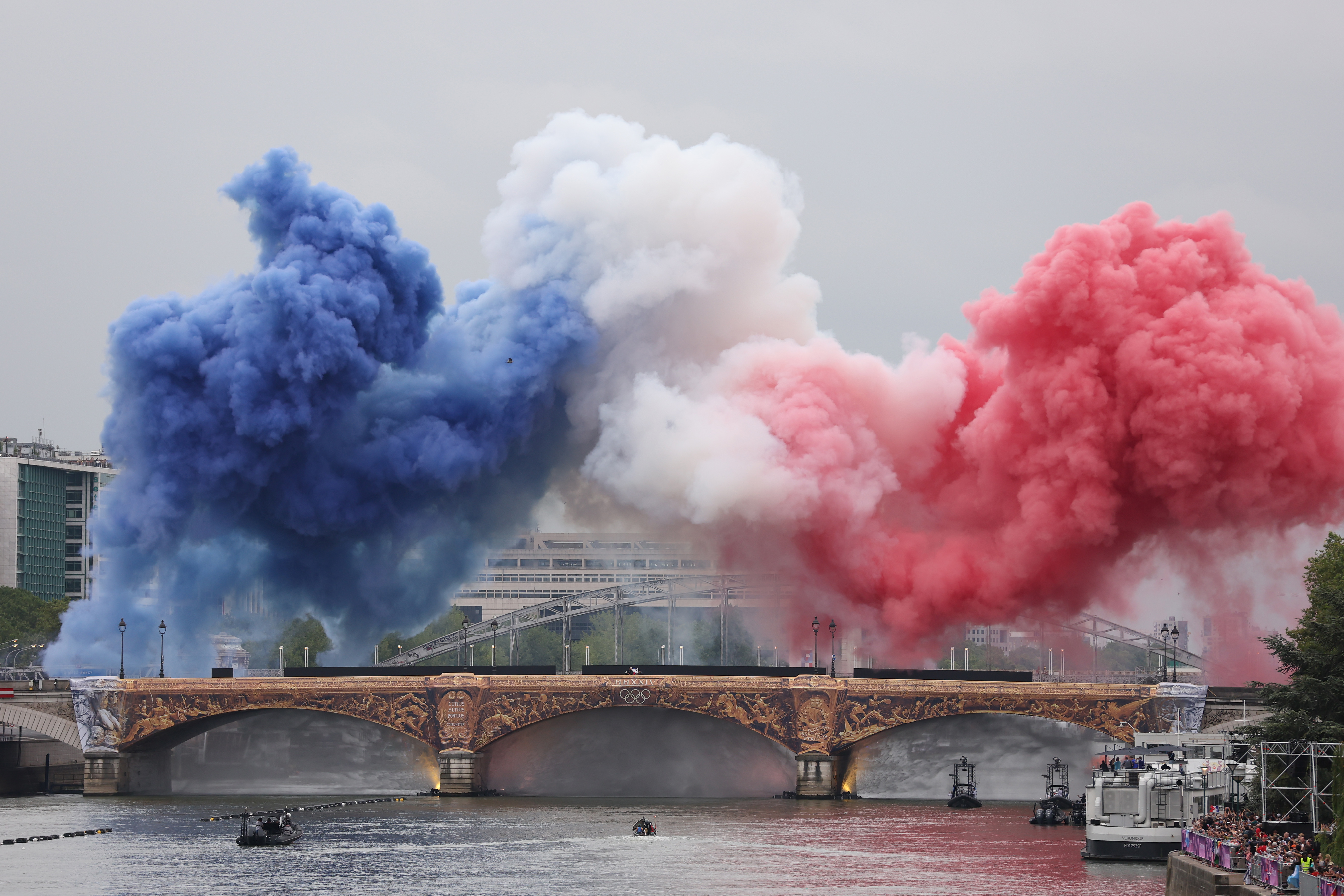 Smoke resembling the flag of Team France is shown over Pont d’Austerlitz during the opening ceremony of the Olympic Games Paris 2024 in Paris, France, on July 26, 2024. | Source: Getty Images