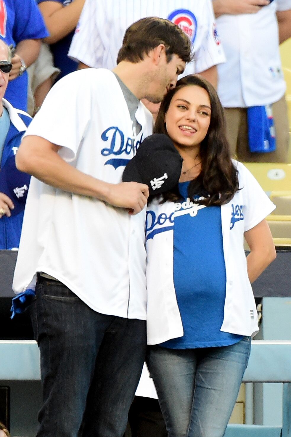 Ashton Kutcher and wife Mila Kunis on the field after they announced the Los Angeles Dodgers starting lineup before game four of the National League Championship Series | Getty Images