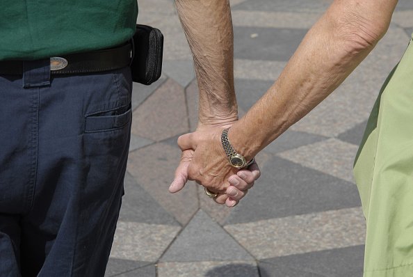Elderly couple holding hands | Source: Getty Images
