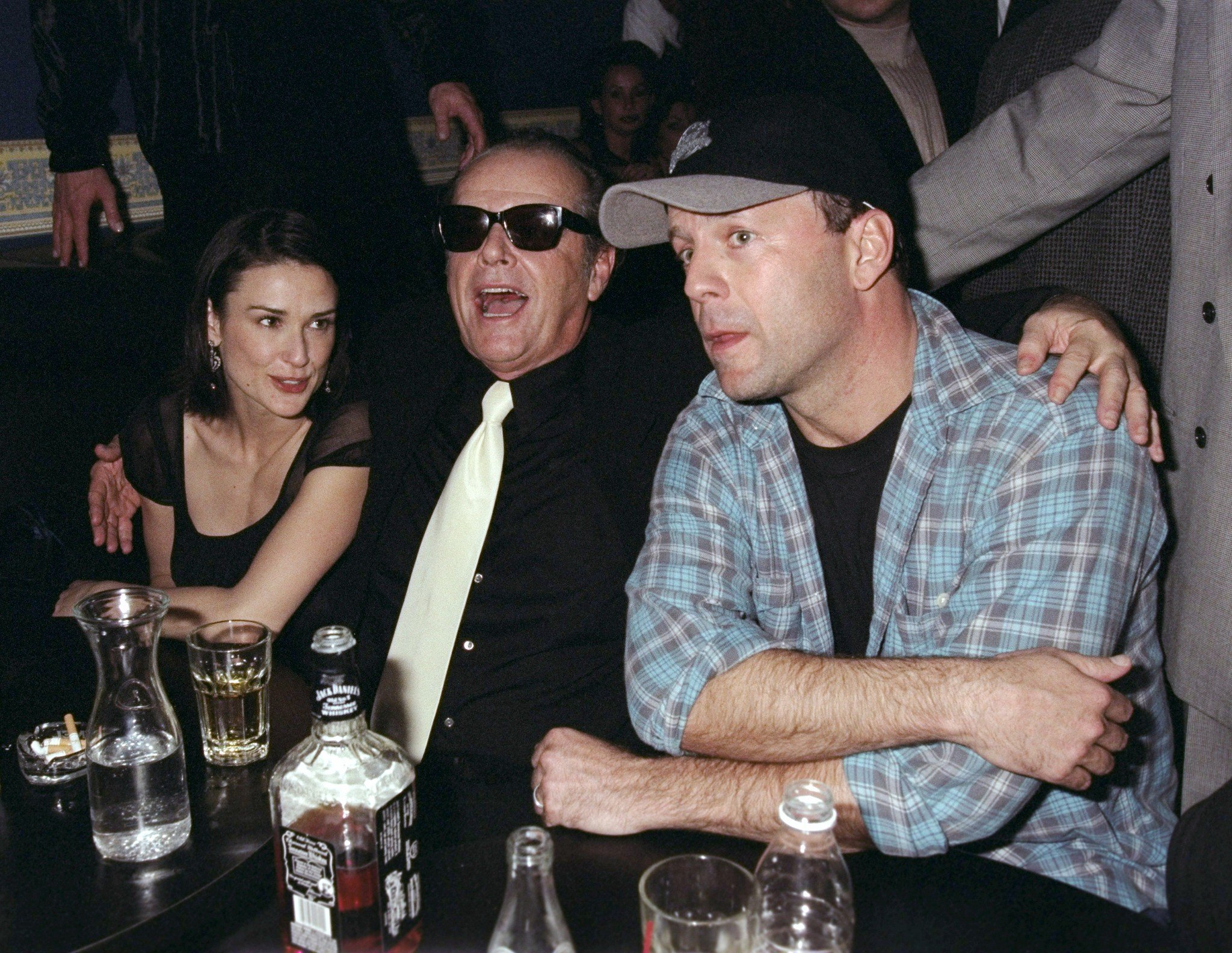 Demi Moore, Jack Nicholson, and Bruce Willis share a table at the China Club, on February 10, 1998. | Source: Getty Images